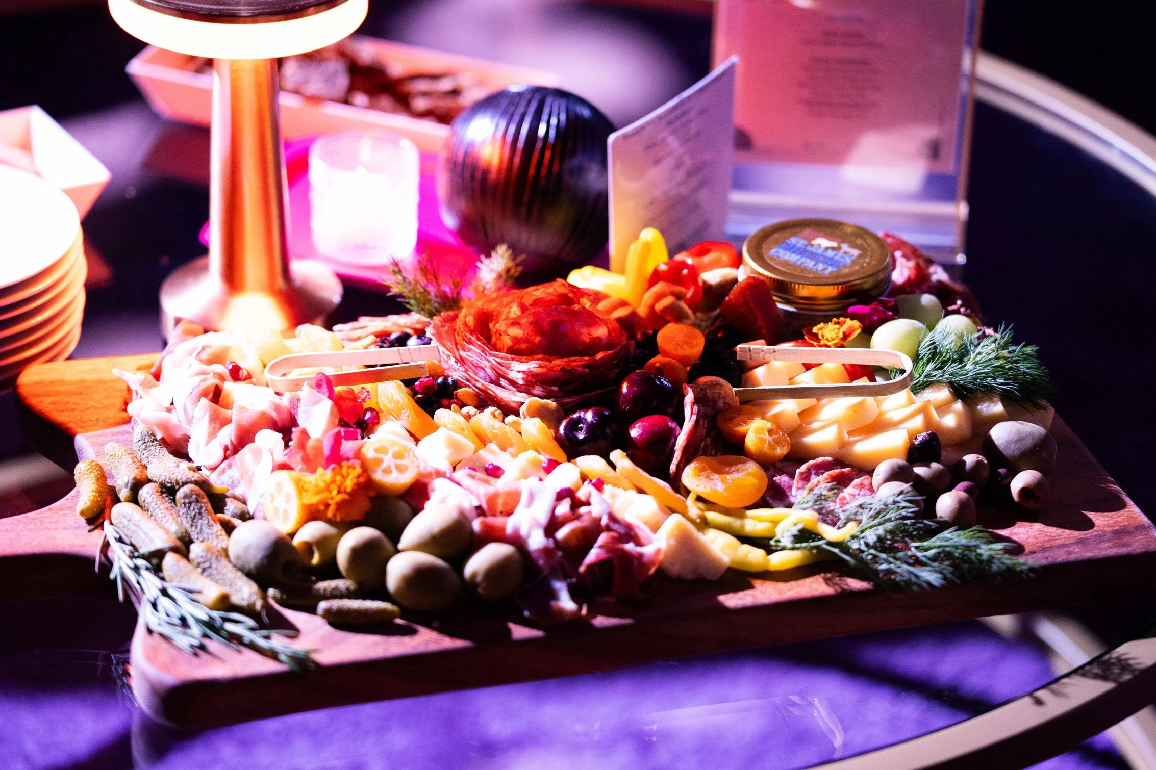 Colorful food display featuring grazing board and fresh ingredients.