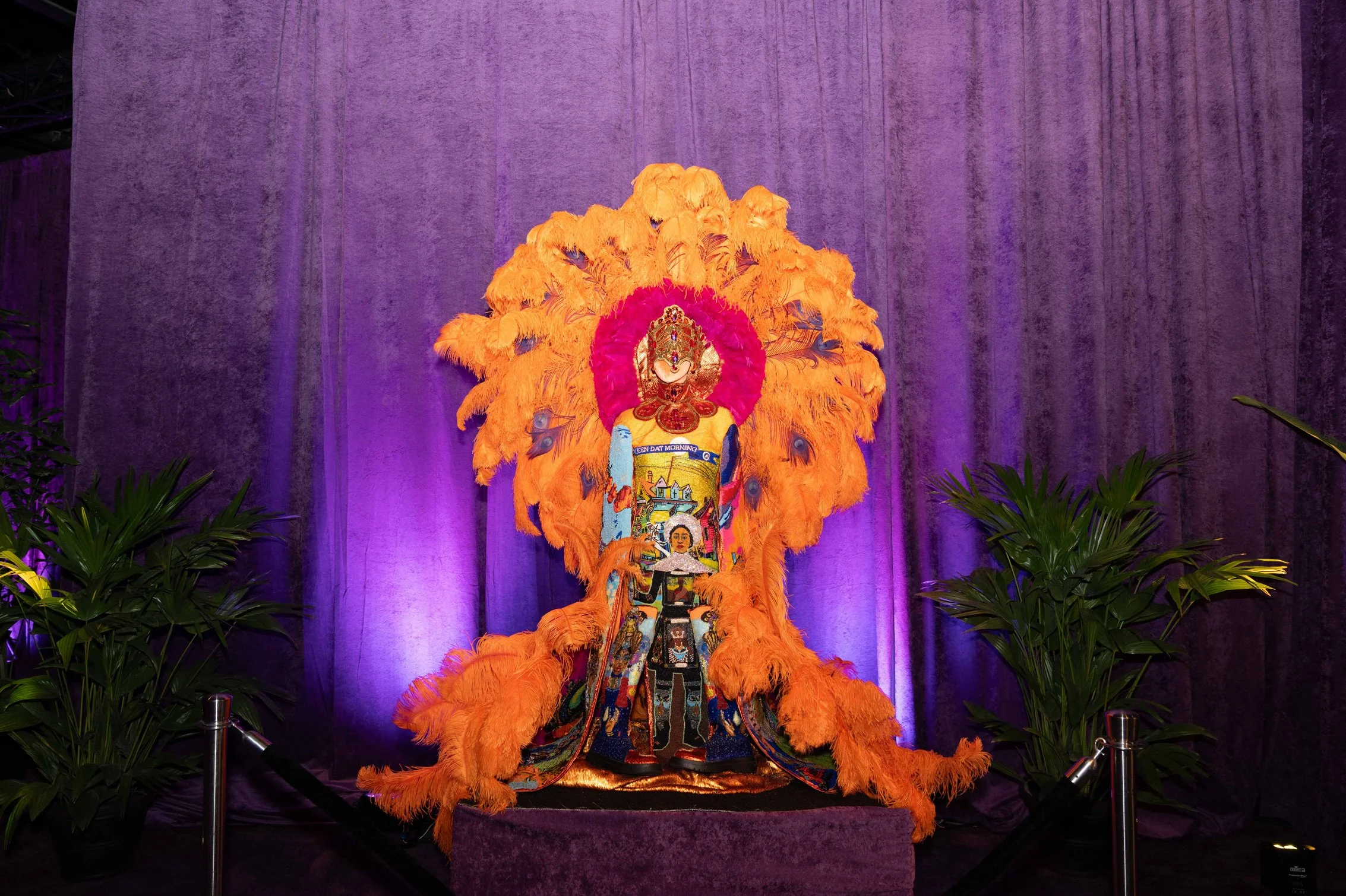 Ornate floral and sculptural event installation with purple lighting.