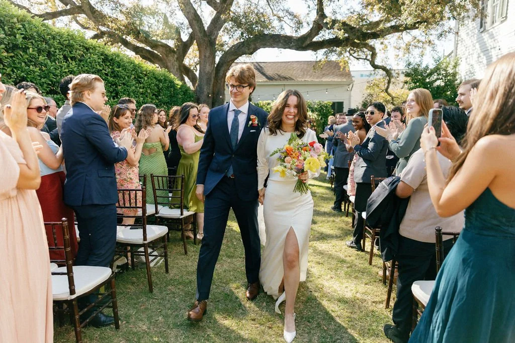 Brooke and Niels celebrate as guests cheer around them.