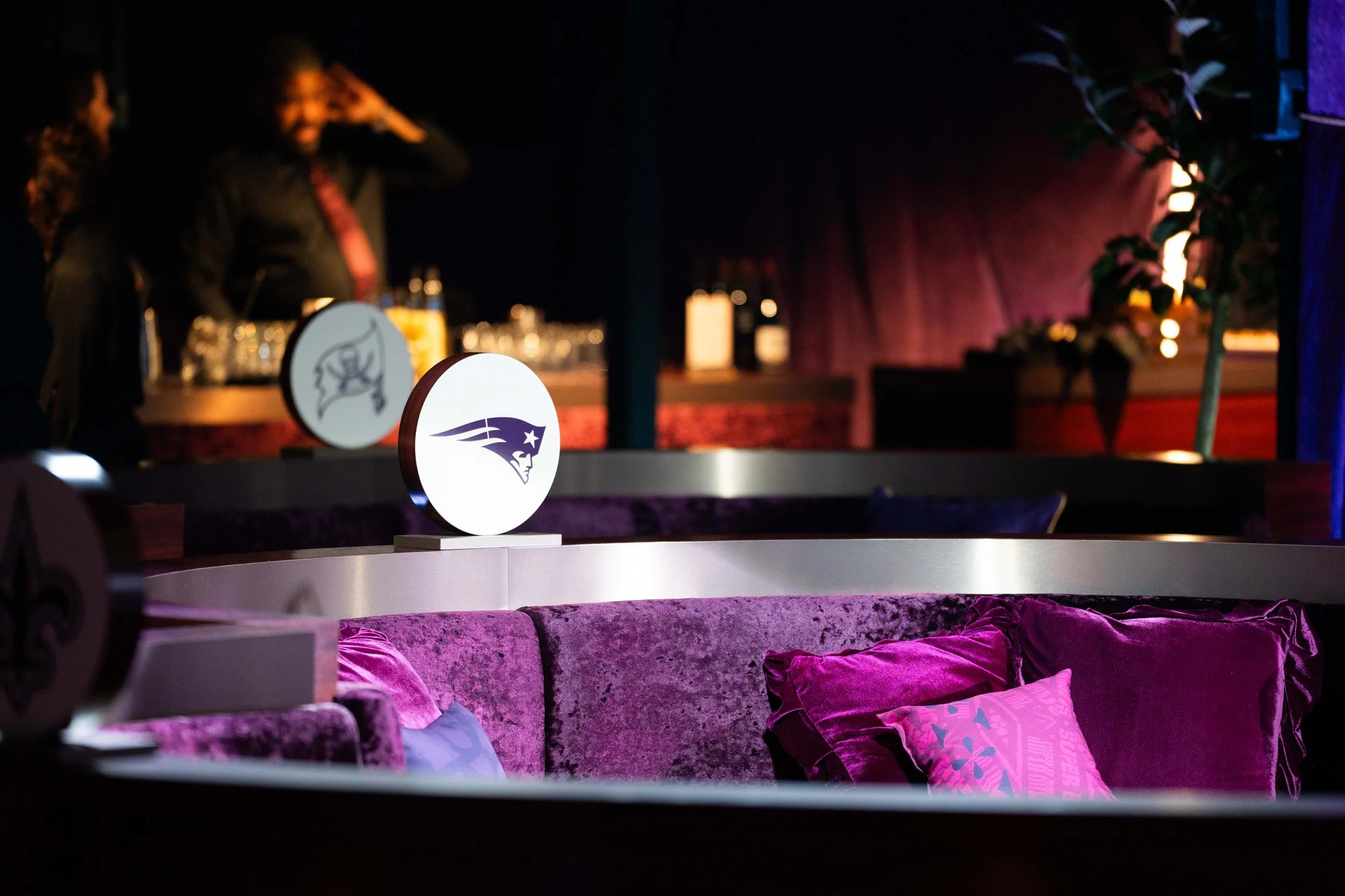 Purple lounge seating and illuminated event décor.