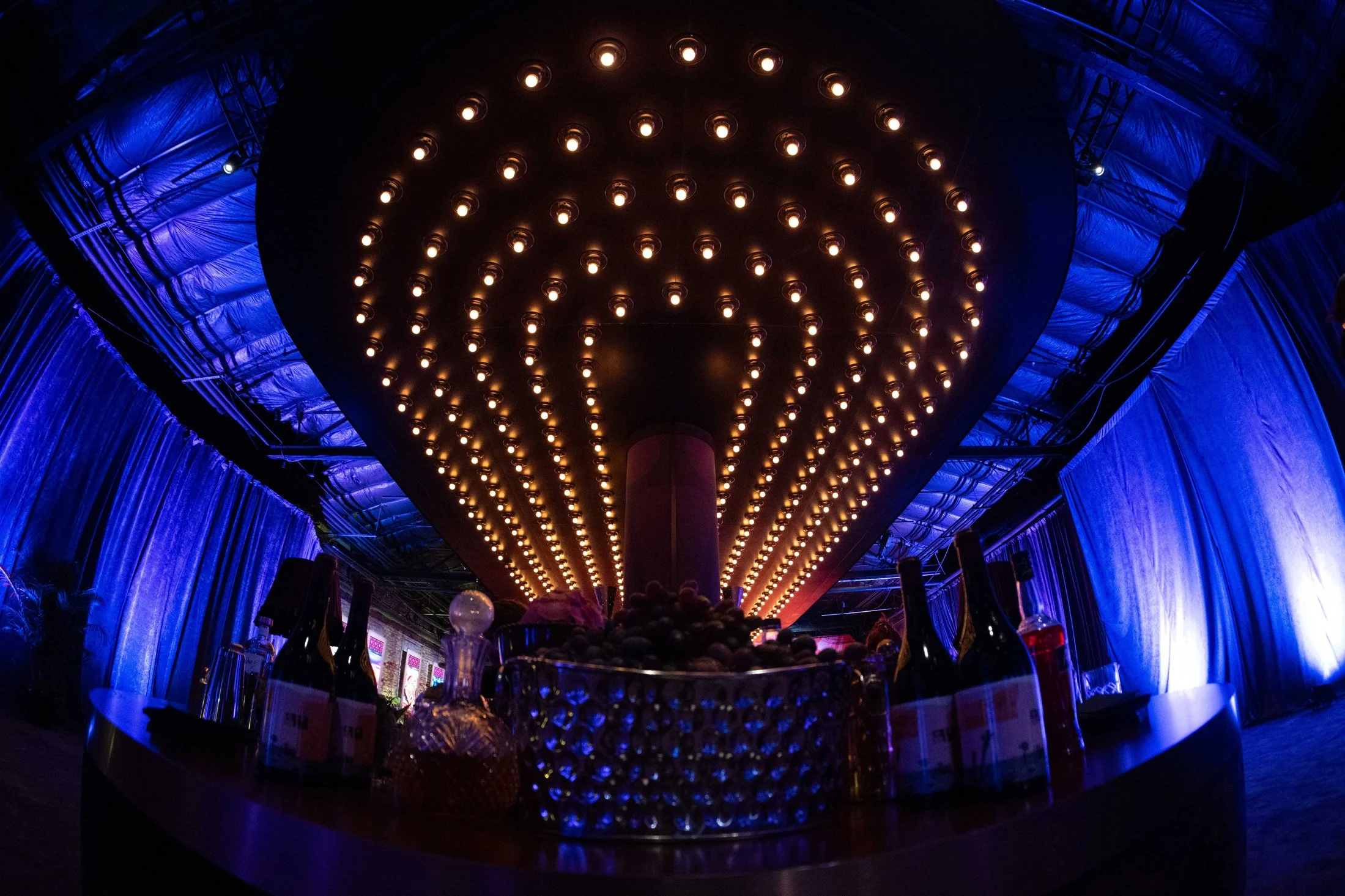 Circular bar beneath a large suspended light installation.