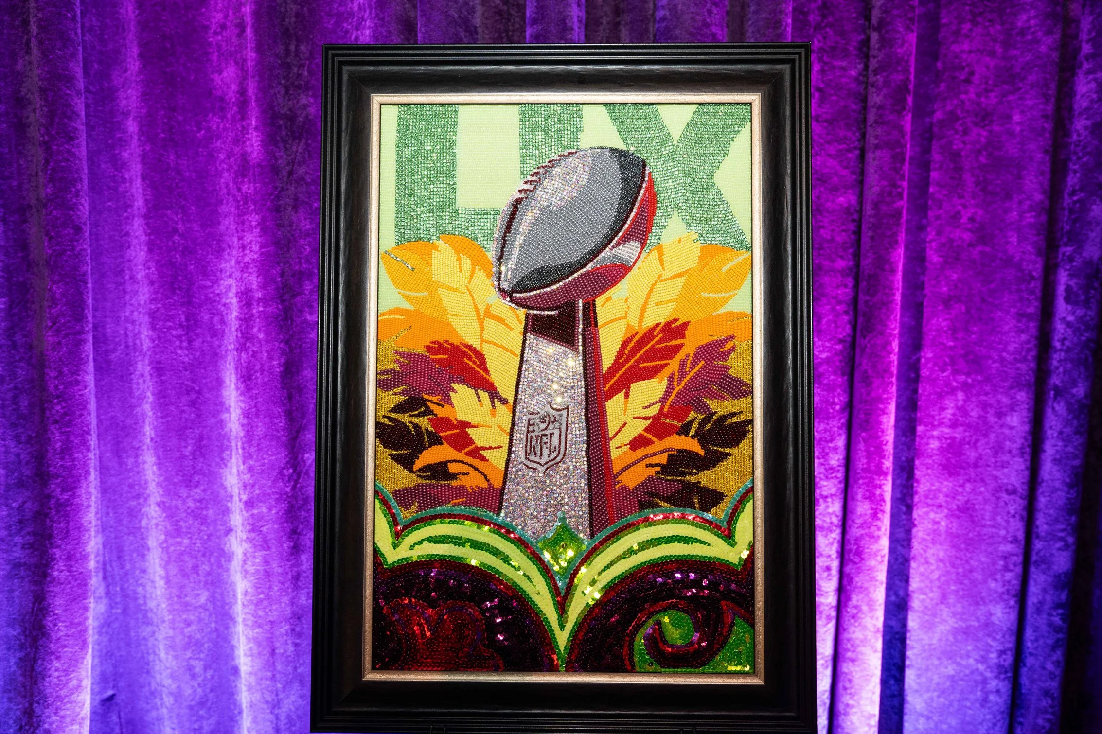 Framed New Orleans-inspired artwork illuminated with purple lighting.