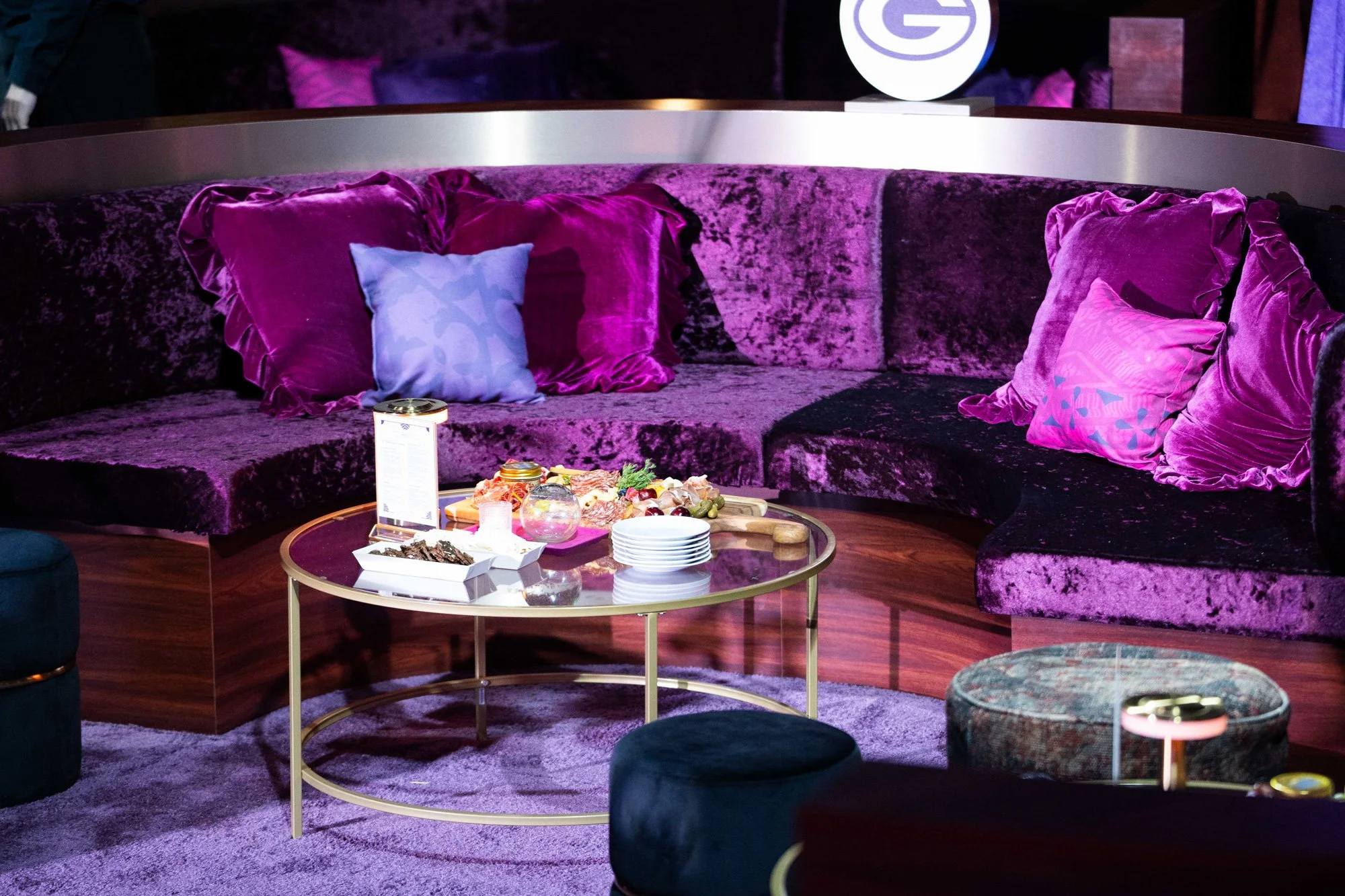 Lounge area with purple seating and cocktail tables.