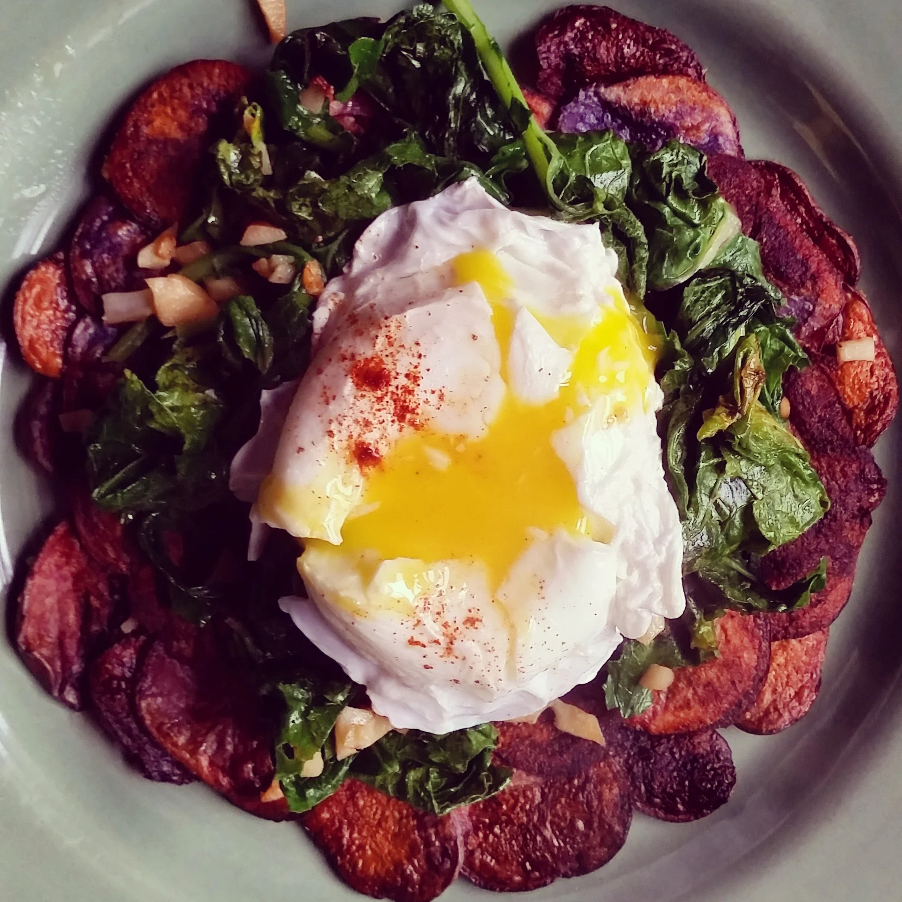 Crispy Purple Potatoes and Garlicky Turnip Greens topped with a Poached Egg