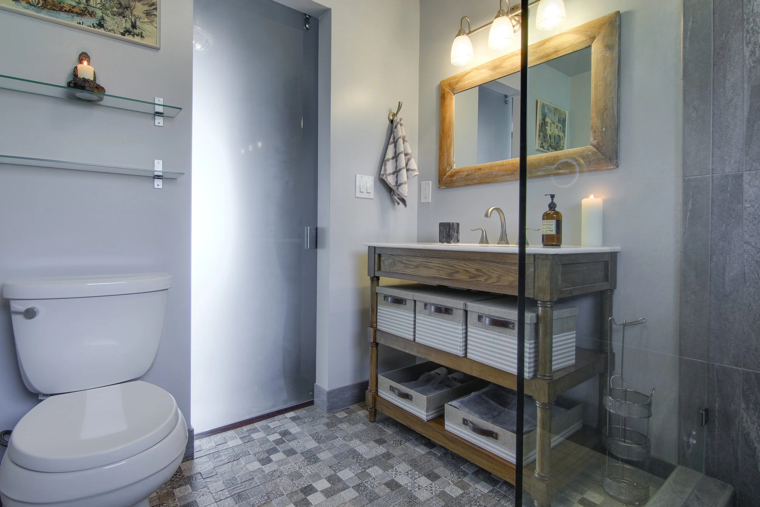 After- The glass barn door illuminates the bathroom with natural light.