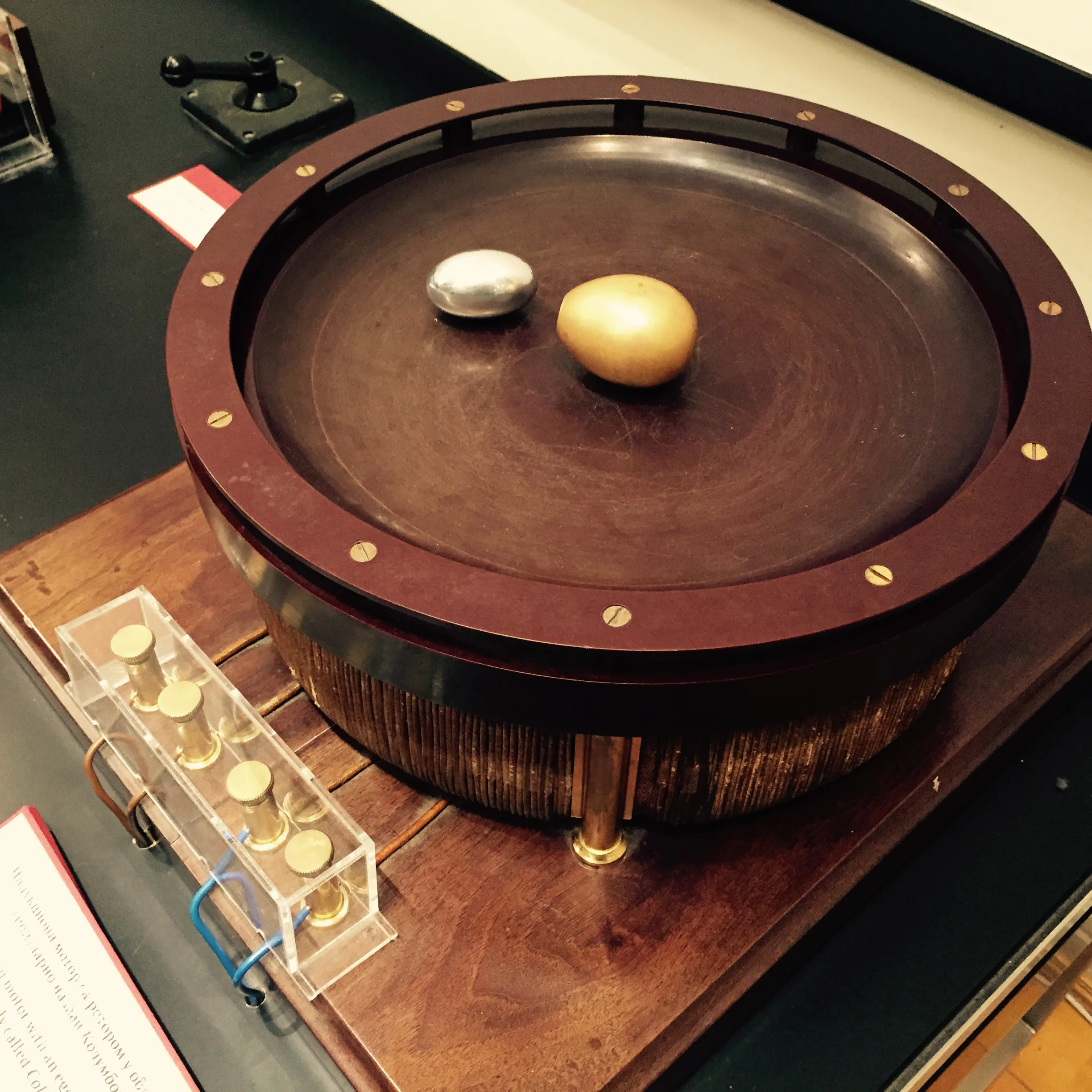 Replica of Tesla's Egg of Columbus demonstration apparatus employing a rotating magnetic field on top of which sits their copper egg and our aluminum PhiTOP.