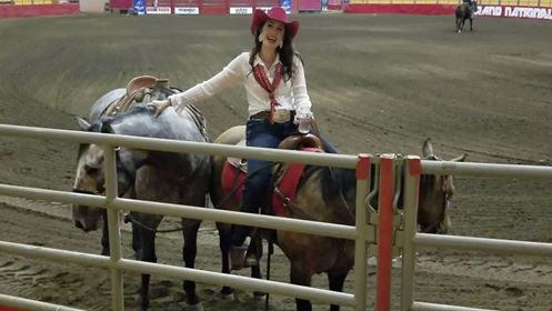 E-Communications Manager Paige Ryan, with Honest Abe (left) and Mouse (right), introduces the press to the Grand National Rodeo at the Cow Palace. (Still from video by Jeff Kaliss)