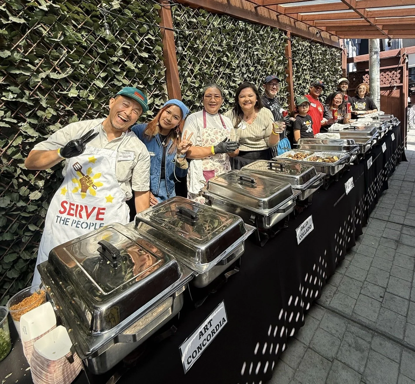 Six contestants serving their adobo recipes at the 2026 Adobo Cookoff at 7 Mile House in Brisbane, California.