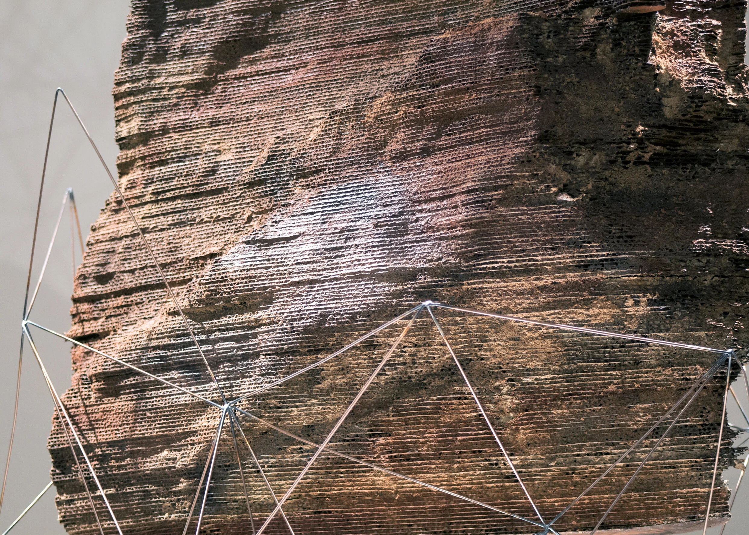 Synthetic Erosion II Cardboard, welding rod, paint, sawdust, mirror, 130 x 50 x 90 in., 2021 Sculpture created from a 3D scanned rock. This work questions what humans consider to be natural, particularly the perception that nature is outside of human society. The materials blur the distinction between what is considered to be stereotypically natural and human-made.