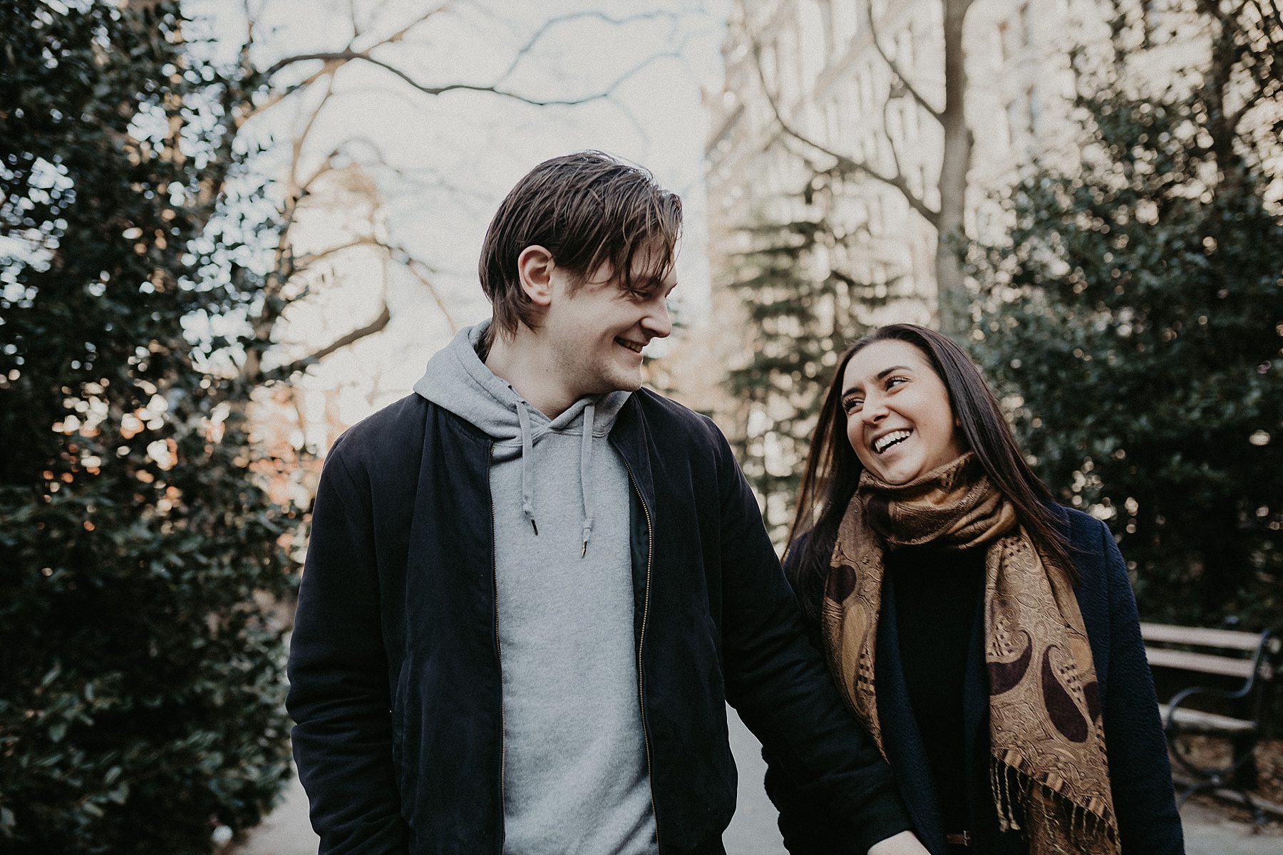 Couple in love having engagement photos taken in Washington Square Park in New York City, New York