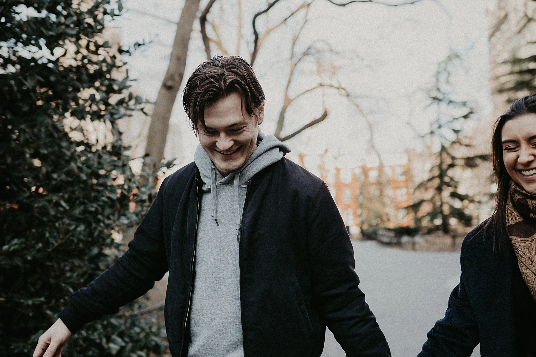 Couple strolling through Washington Square Park during engagement session in New York City, New York