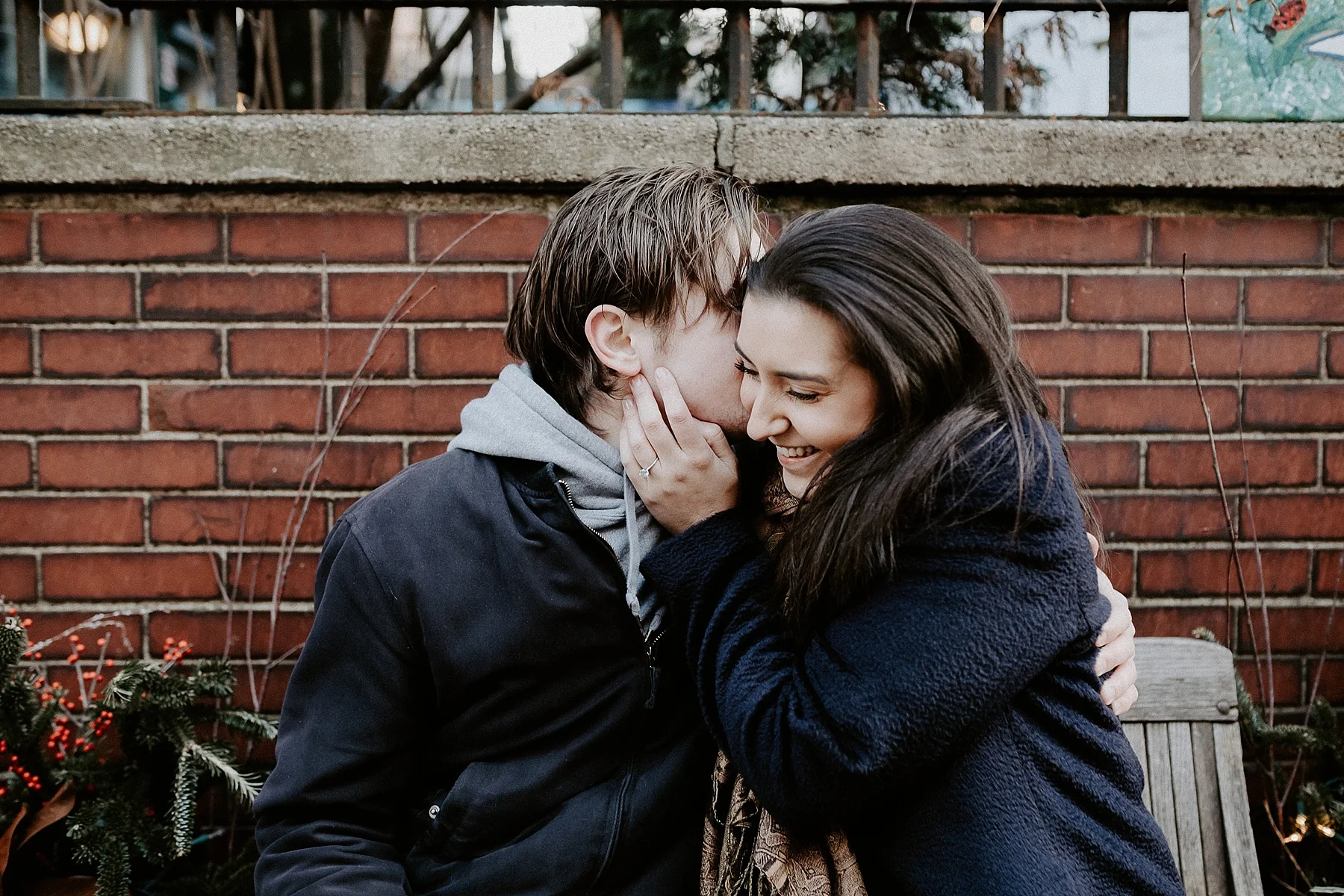 Couple kissing and cuddling sitting on a bench in Greenwich in New York City, New York