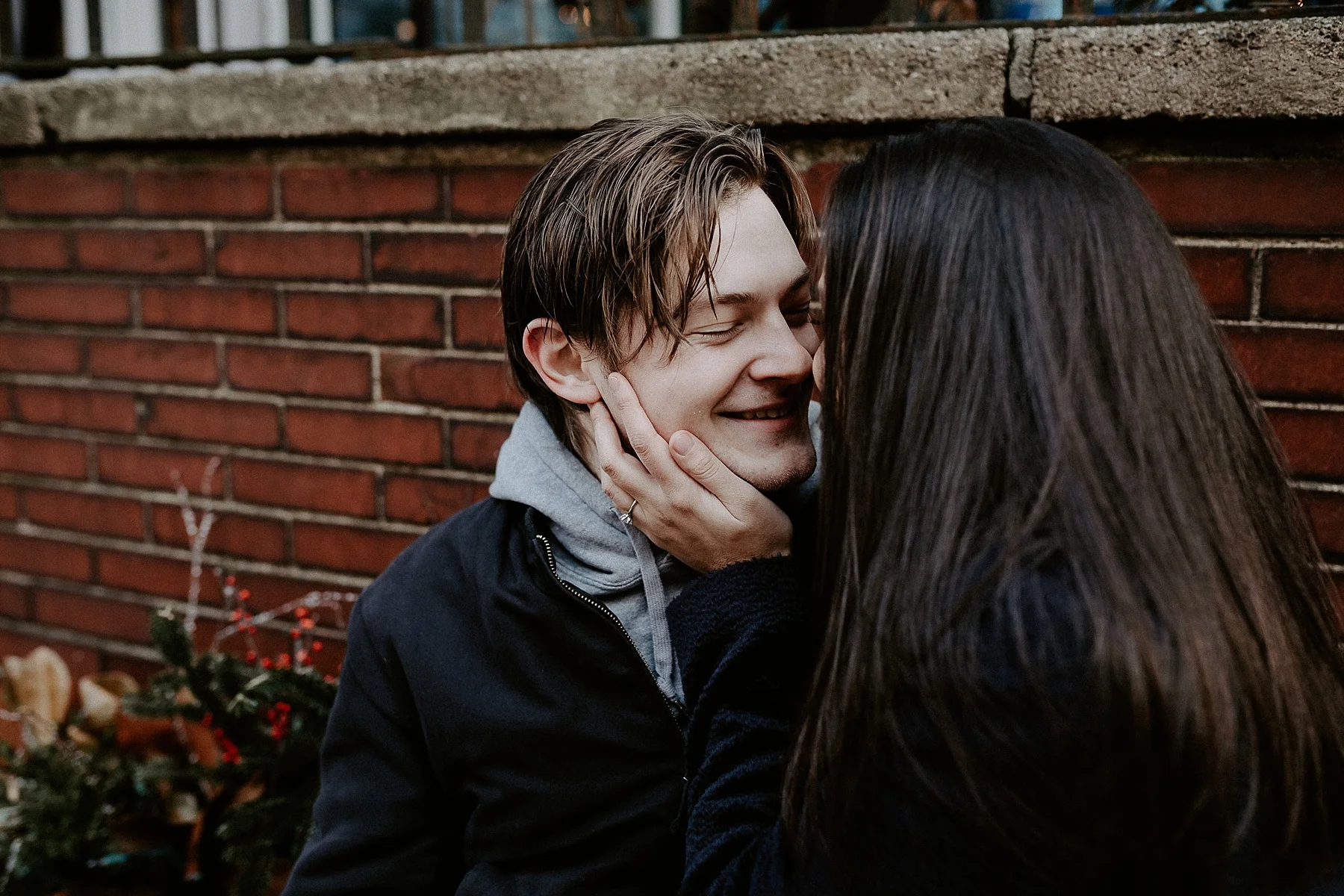 Couple having a sweet moment together on a bench in Greenwich Village in New York City, New York