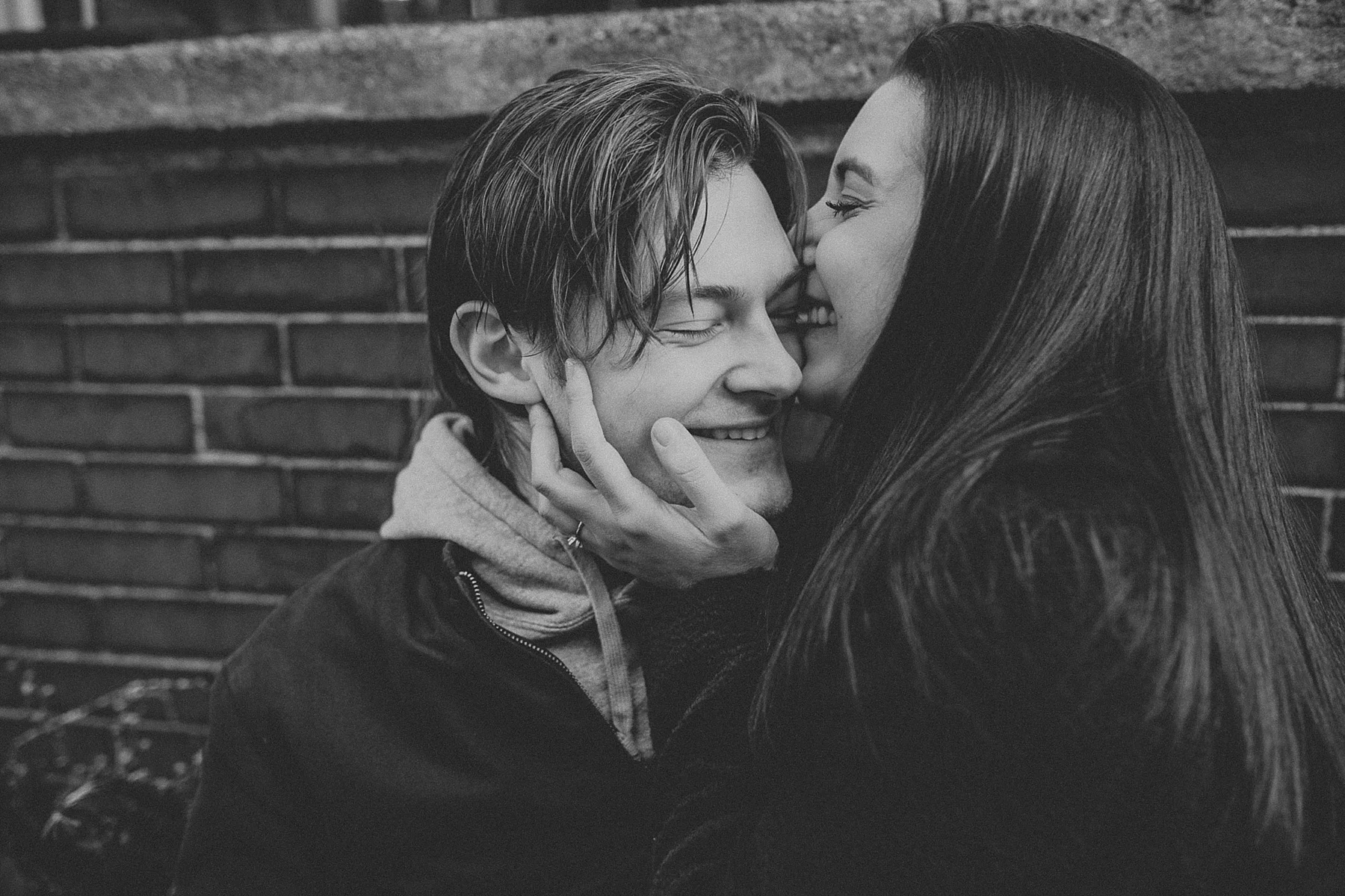 Couple having a sweet moment together on a bench in Greenwich Village in New York City, New York
