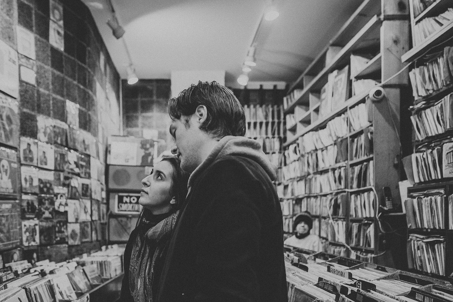 Couple hanging out in record store and shopping for vinyls during engagement session in Greenwich Village, New York City, New York