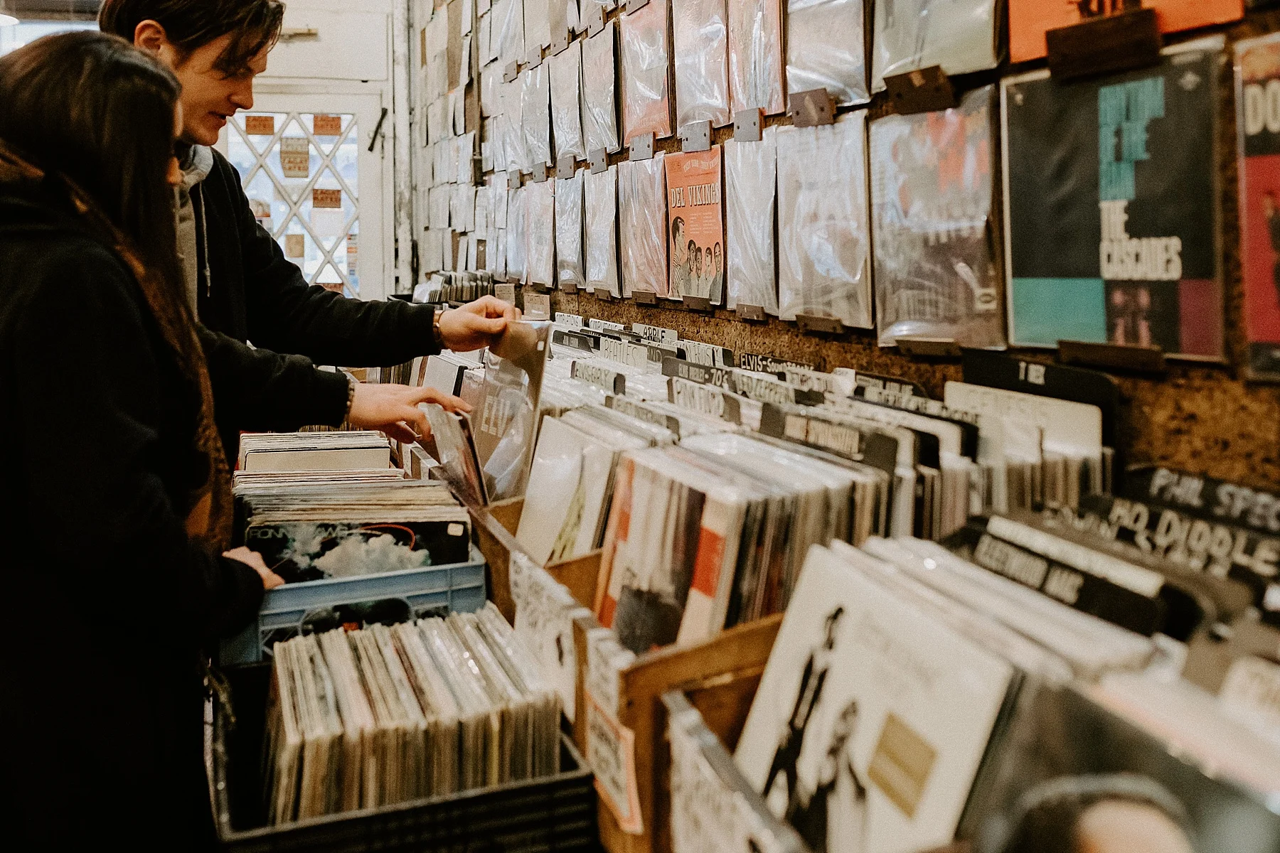Couple hanging out in record store and shopping for vinyls during engagement session in Greenwich Village, New York City, New York
