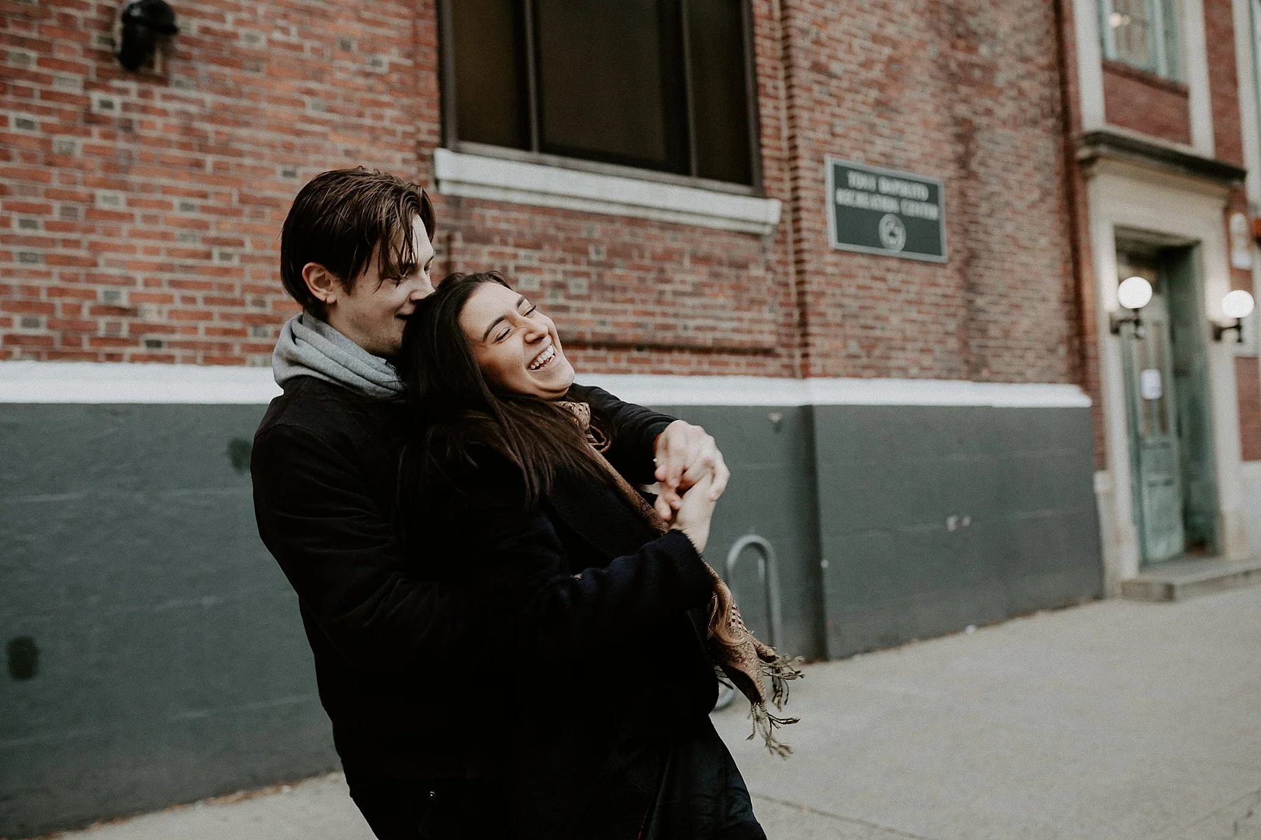 Couple hugging while having fun during engagement session in New York City, New York