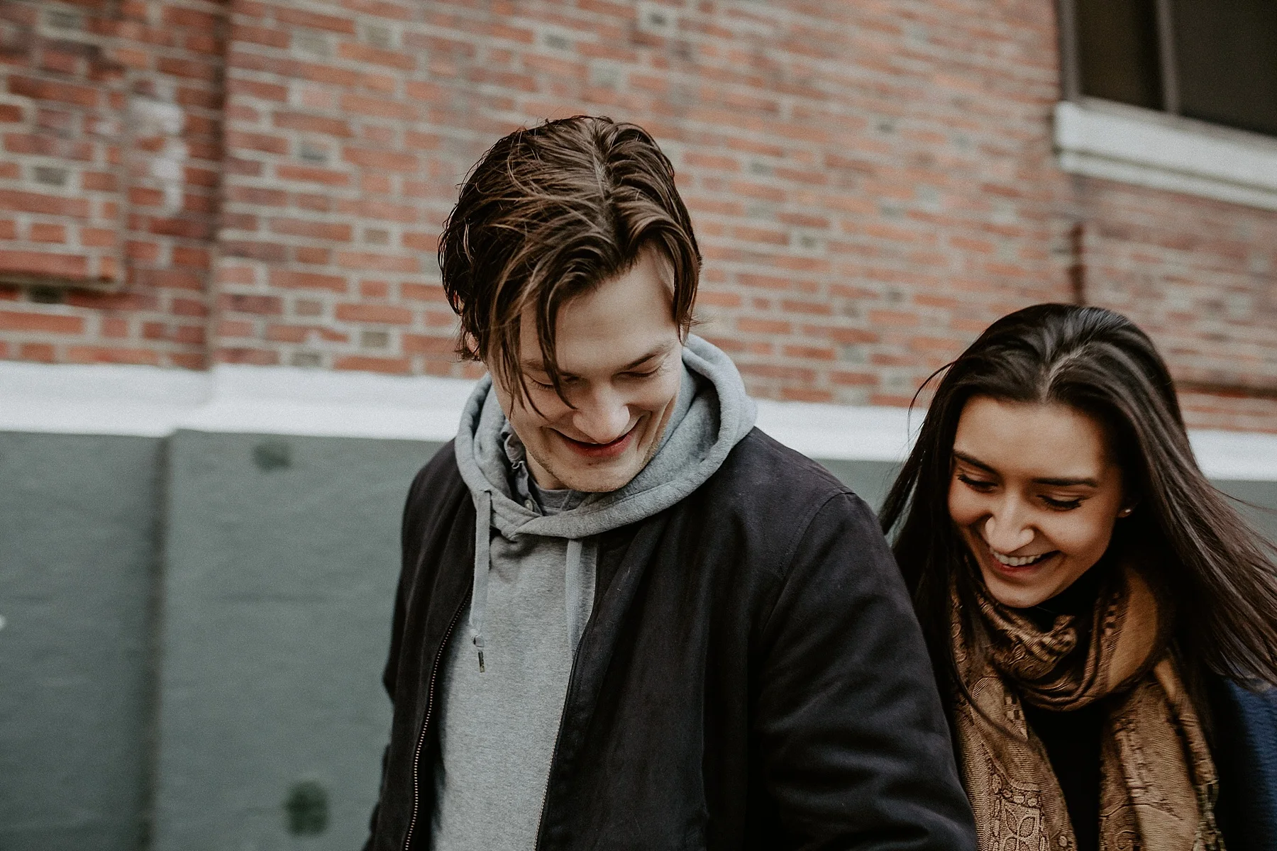 Couple having a sweet and fun moment bumping into one another during engagement session in New York City, New York