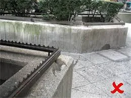 An uninviting privately-owned public space in New York City. Spikes prevent use of the planters for loiterers. And everyone else. Spikes are now prohibited.