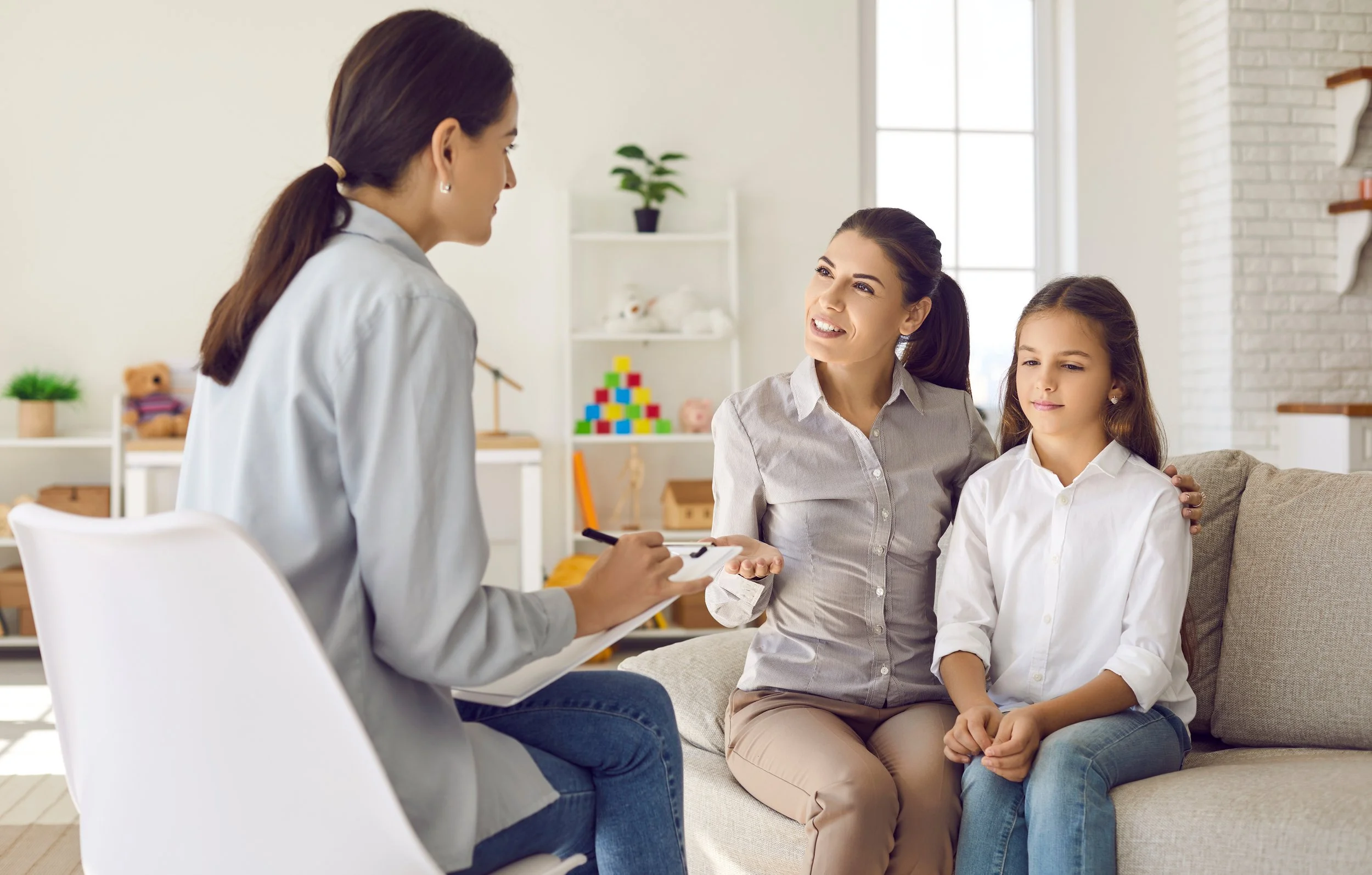 Therapist meets with parent and child with OCD to coach the parent on accommodation for adolescent OCD