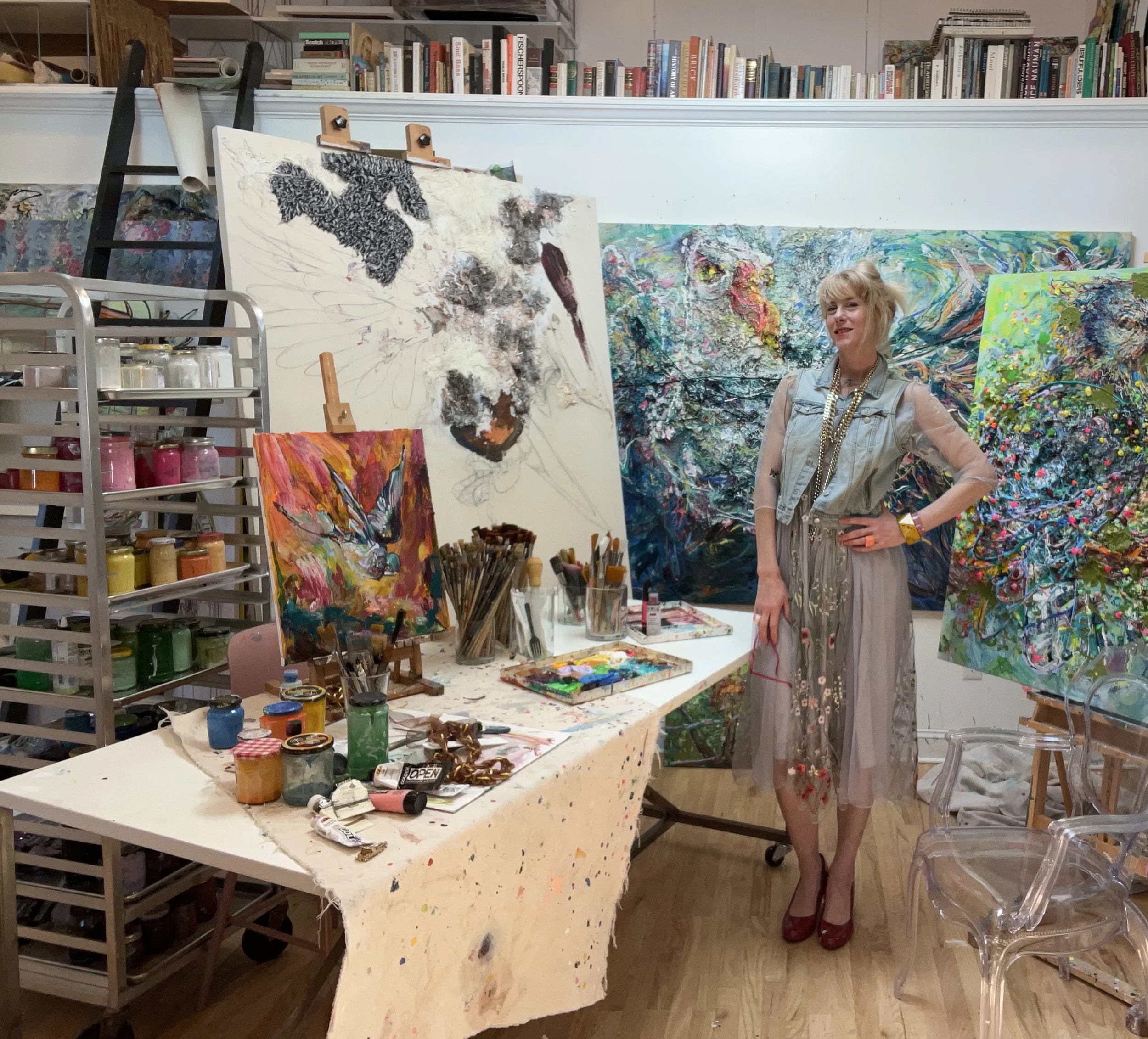 The artist Liz Alderman in her Bronx studio with bird paintings in progress