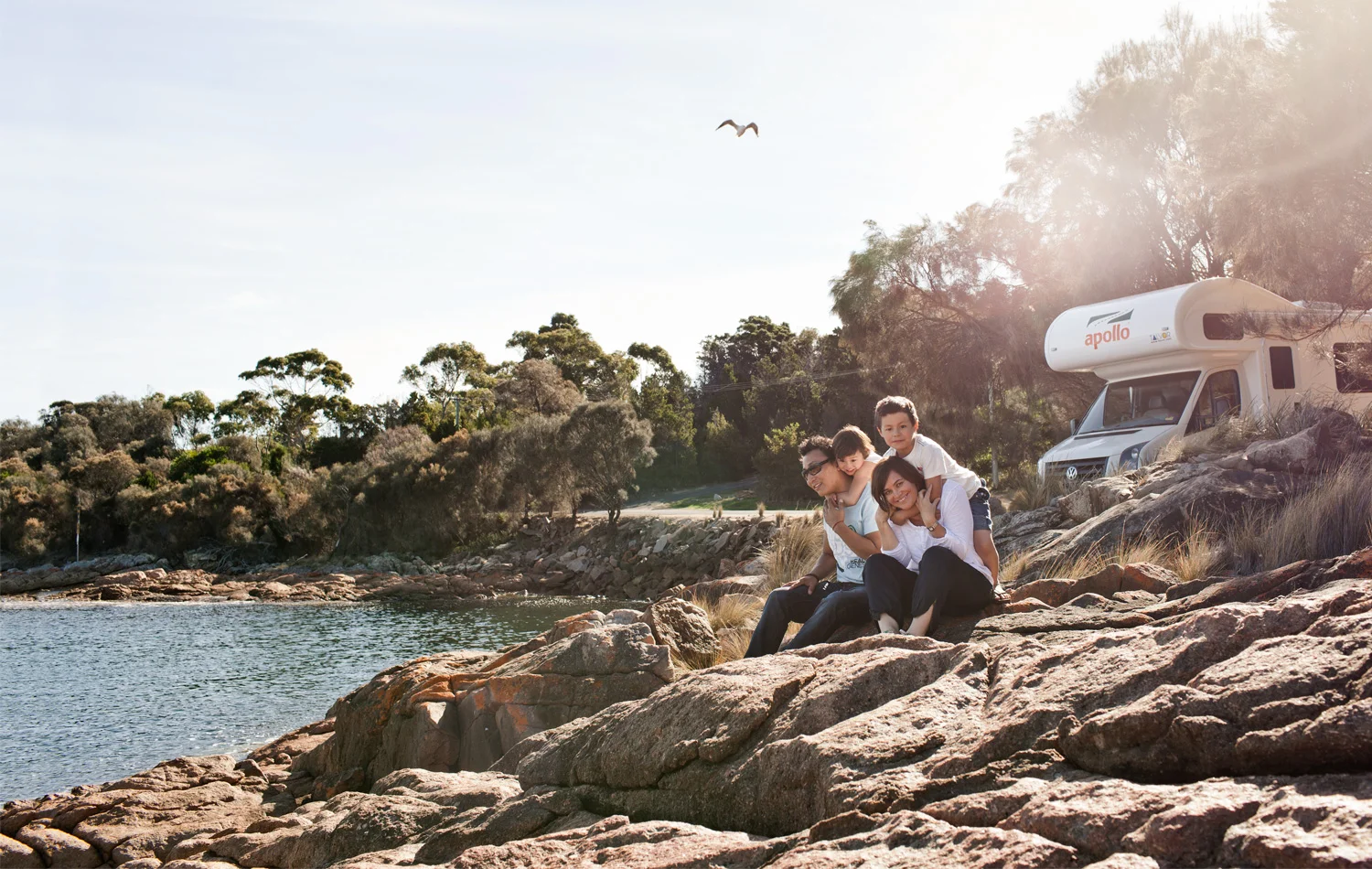 Shakya, Mila, Tsering and Vanessa take in the beauty of Coles Bay on the Freycinet Peninsula, their trusty campervan close at hand.&nbsp; Photograph by Sean Fennessy.
