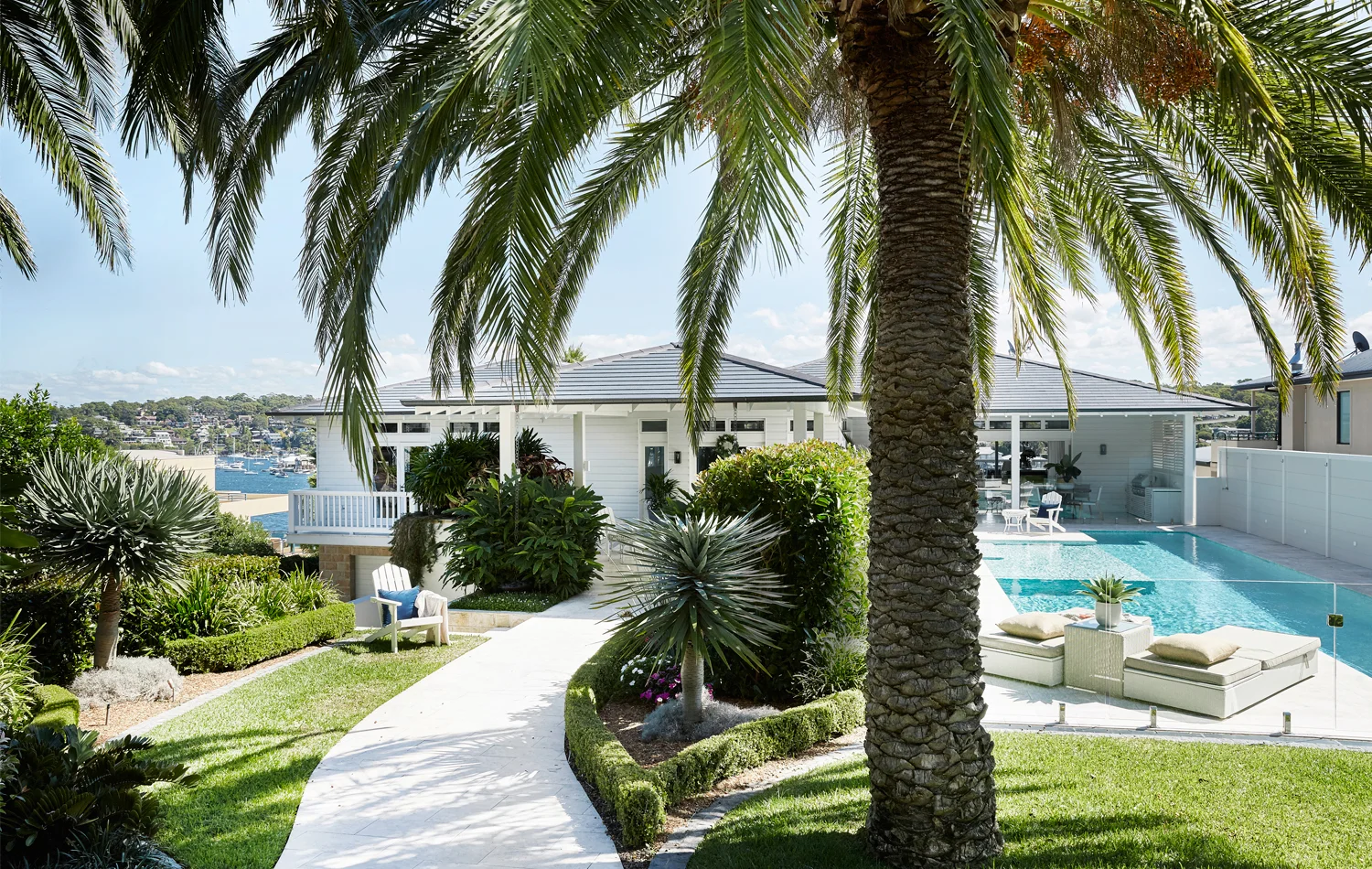 Frequent entertainers, the owners of this bayside home in southern Sydney wanted to wow their guests from the outset. Mature date palms, a granite path and immediate view of the 15m pool do the trick. PHOTOGRAPHY John Paul Urizar.