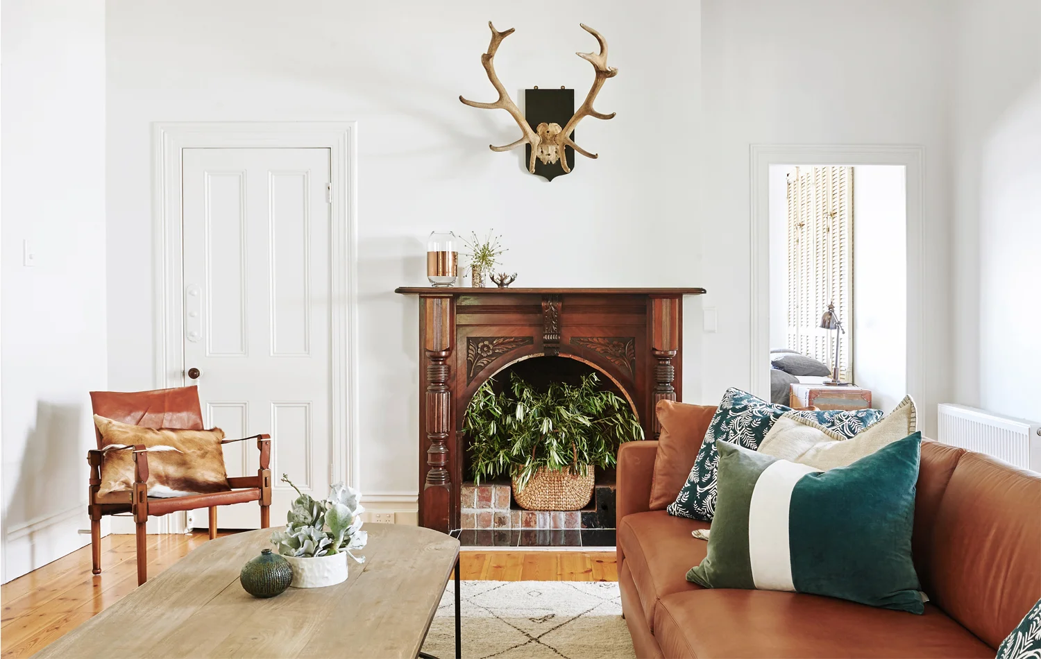 Olive branches cut from an established tree at the rear of the property splay out of a basket in the fireplace. Photography Nikole Ramsay.