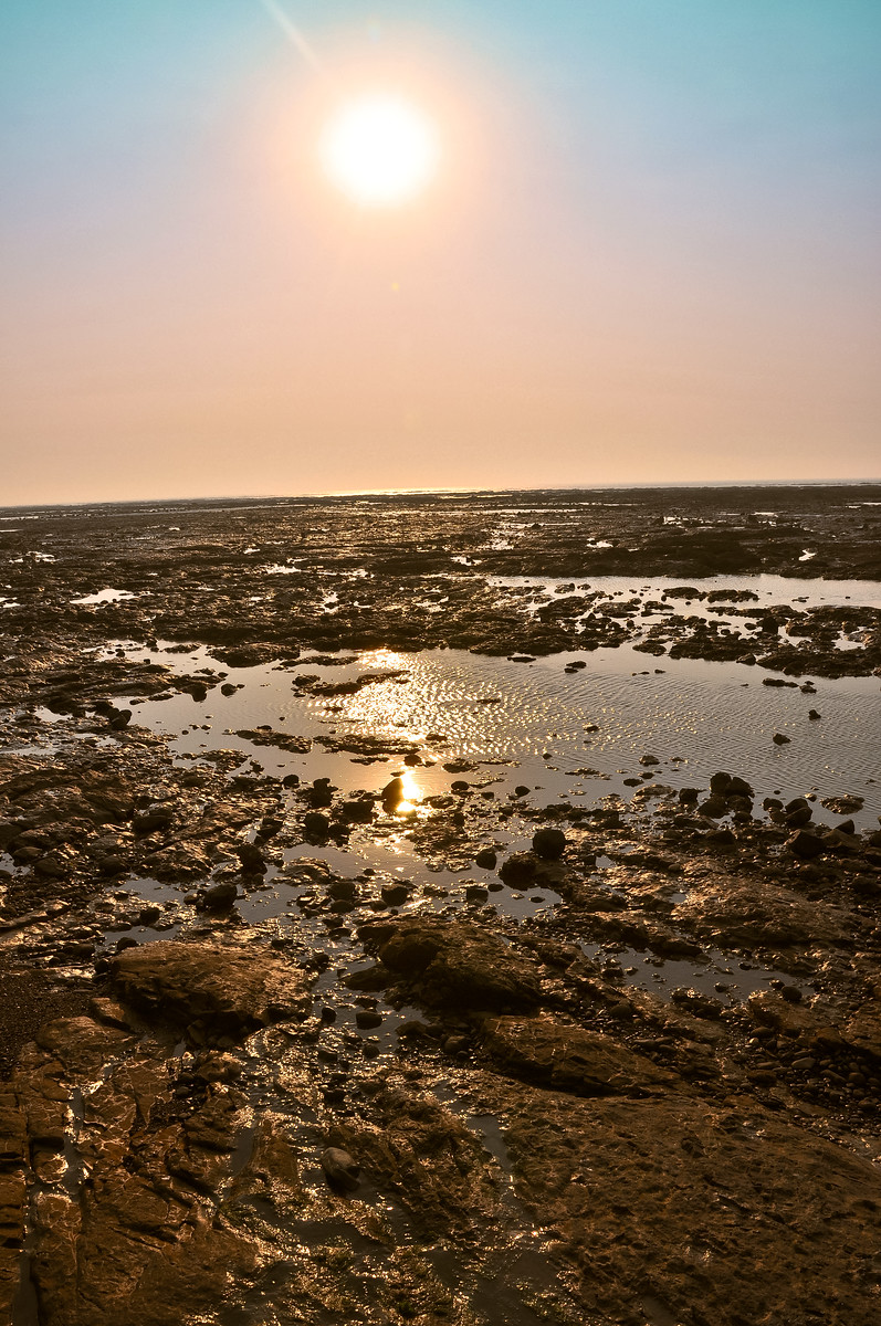 A hazey sunset over the beach at Daman