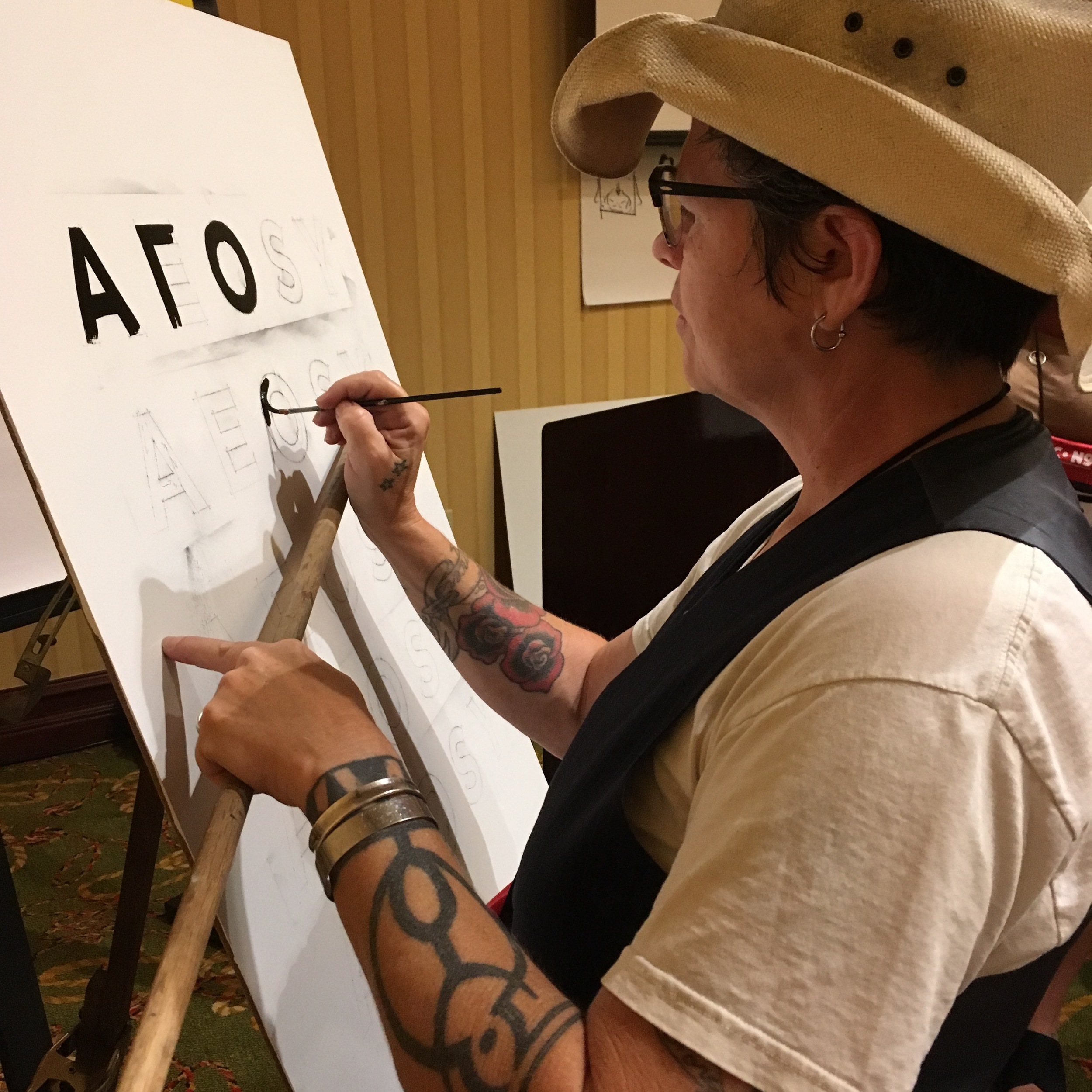 Norma Jeanne demonstrating her technique on the tricky "O" utilizing a mahl stick and quill #4. We practiced an A, E, O, S and Y - the five letters that exemplify all the lines, curves, diagonals and symmetry of the English alphabet.