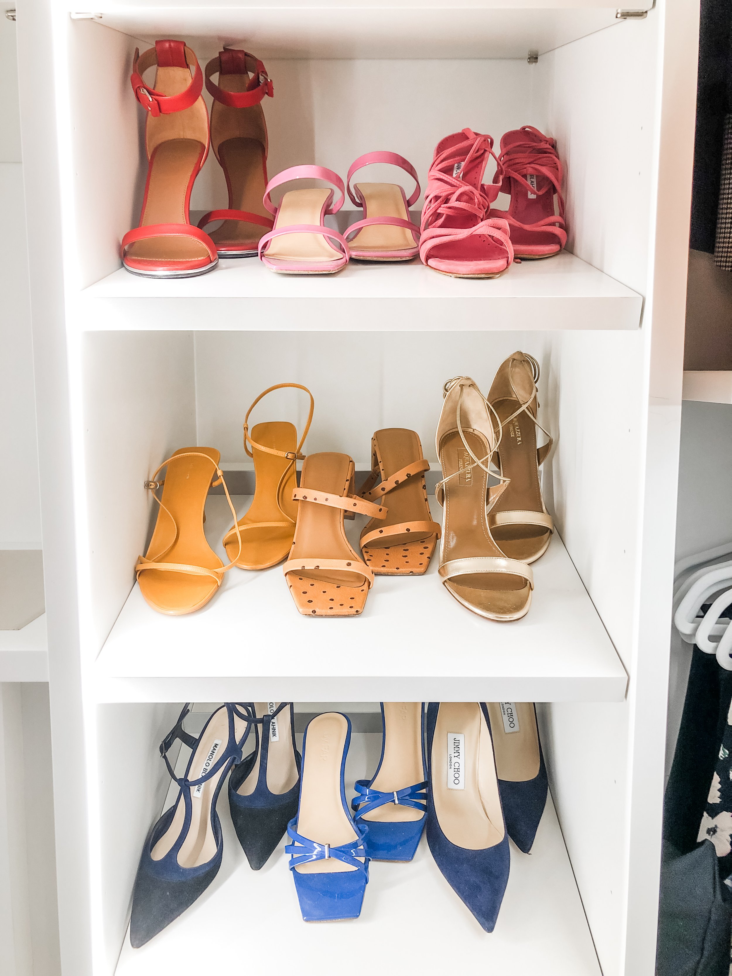 Women's high heels arranged in a closet shelf