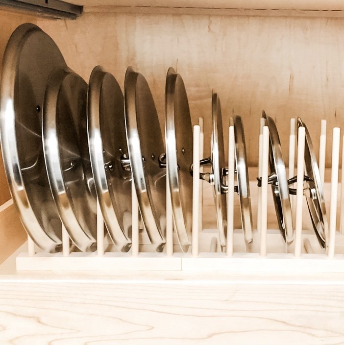 Pot lid organizer inside a kitchen cabinet