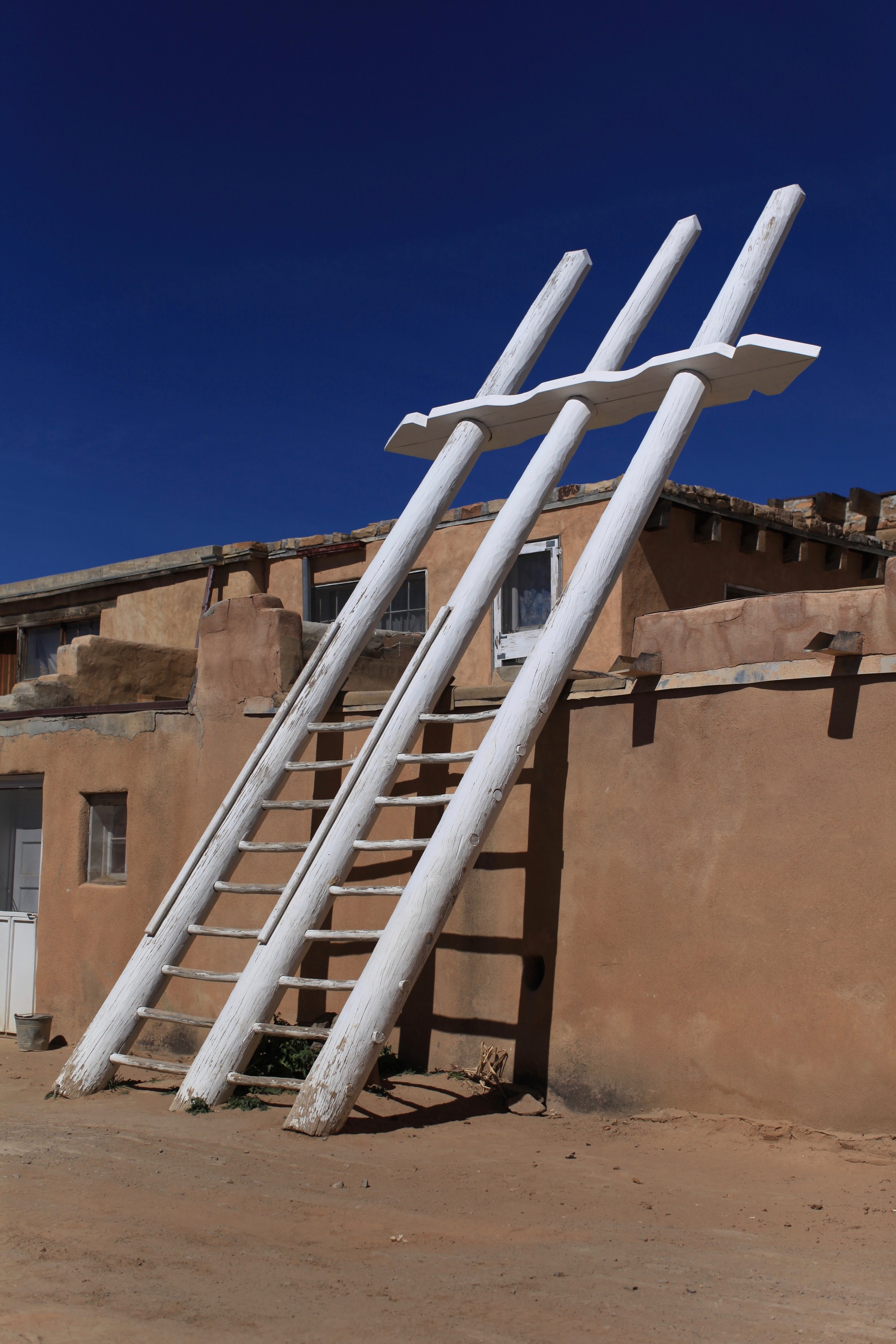  The white ladders that designate a 'kiva' - a house within the Pueblo used for sacred rituals. 