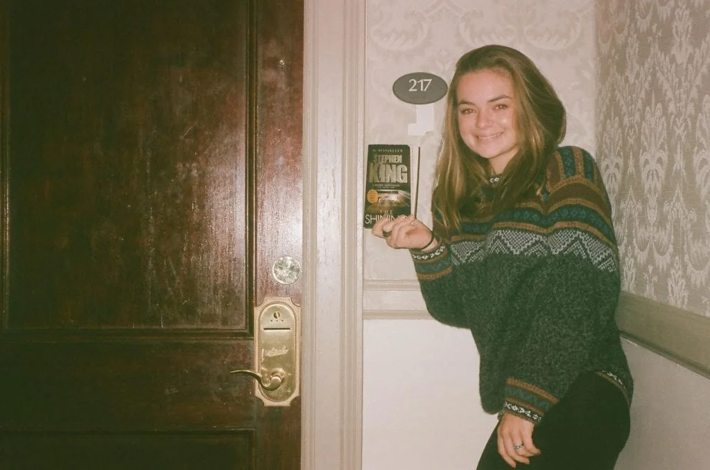 Me standing in front of Room 217, like a true tourist. Spot any orbs? Also, notice the peeling wallpaper under the room badge from where guests had pulled it off the wall.