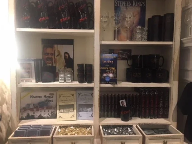 The gift shop wall dedicated to Shining memorabilia--almost a shrine! Prices: Redrum playing cards - $12, Gold, old-fashioned room key - $14 Silver, old-fashioned room key - $14 217 room badge - $15, Redrum mug - $15, The Shining, novel - $17 (mine from Amazon was $9), The Shining, DVD - $15, Redrum shot glass - $12, The Shining wine glass - $14, Coffee travel mug - $22