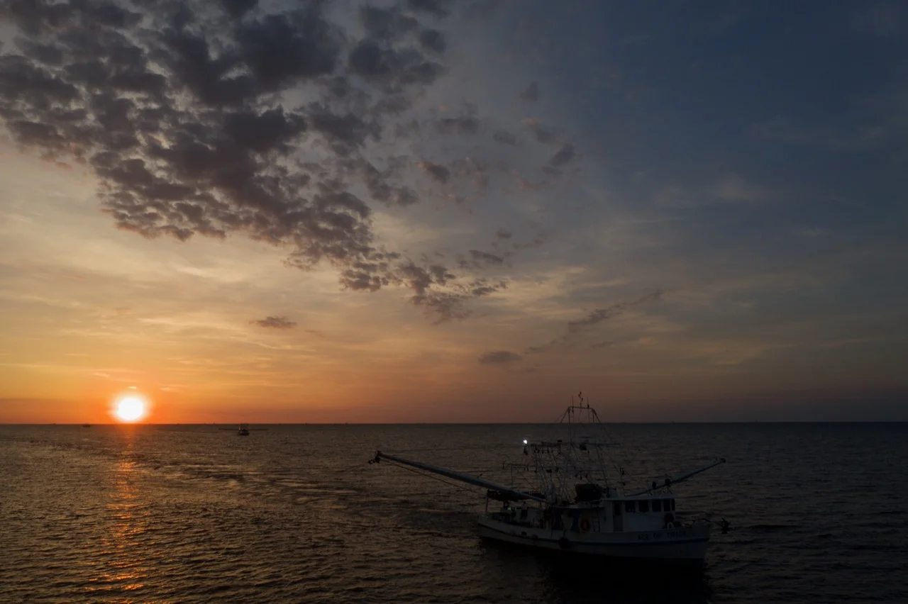 A trawler under the golden sunrise. These fisherman are out all night!