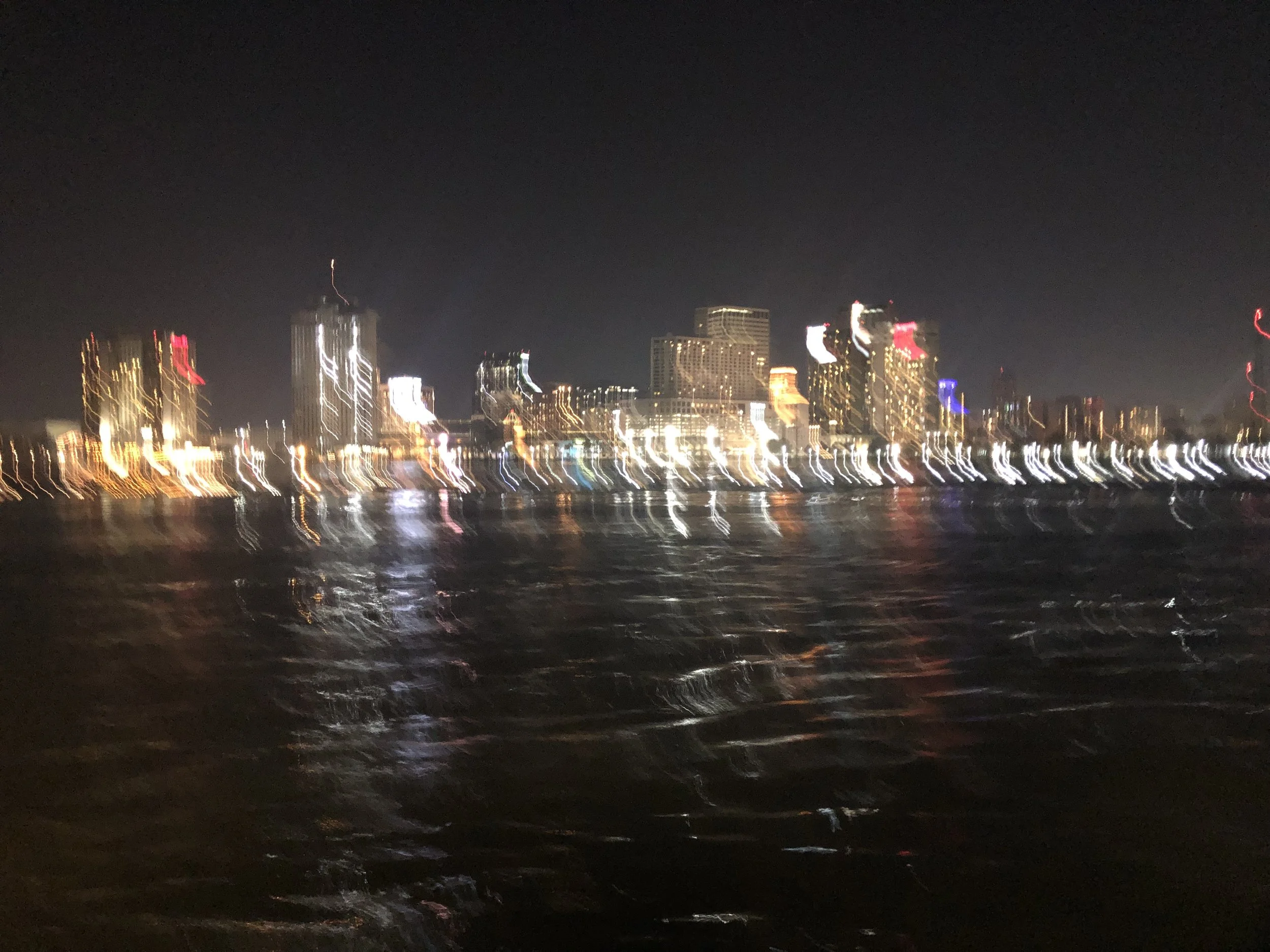 blurry photo of Nighttime New Orleans, taken from the Ferry returning from Algiers.