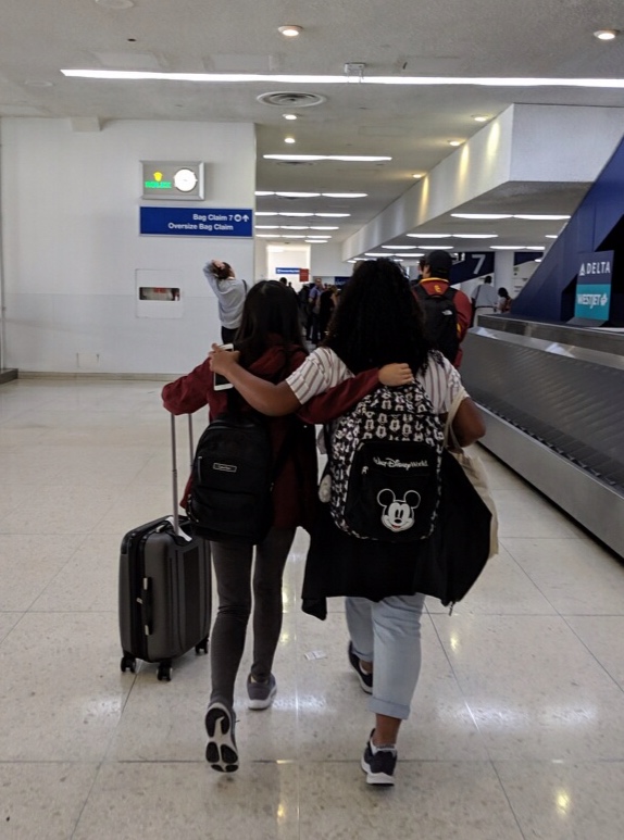 True candid photo of Wendy and I walking in the airport for our baggage.