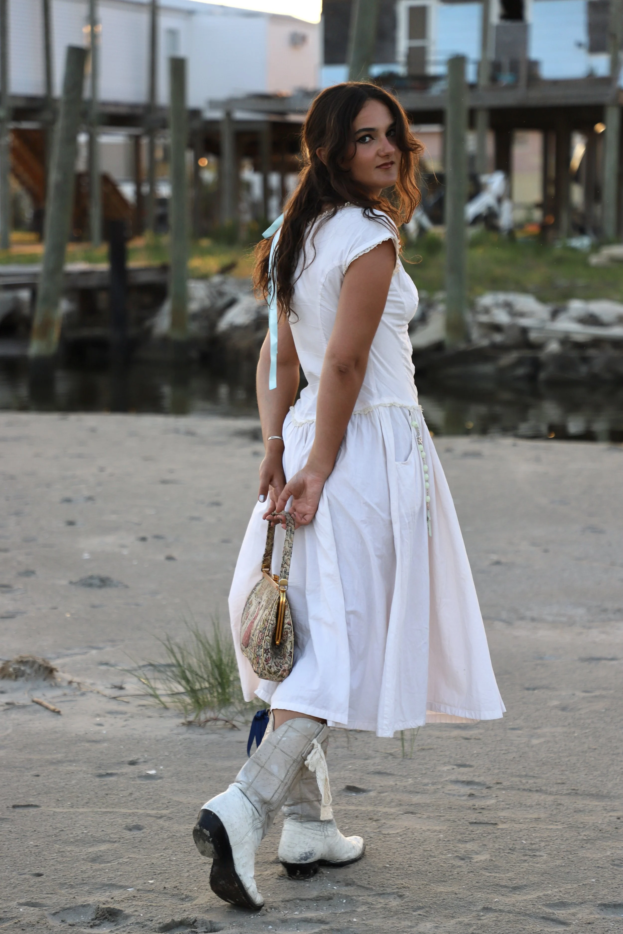  Francesca is walking through the sand of the Grand Isle beaches. During this time, we took all of our portraits on the island during “Golden Hour,” and were simultaneously devoured by bugs.  