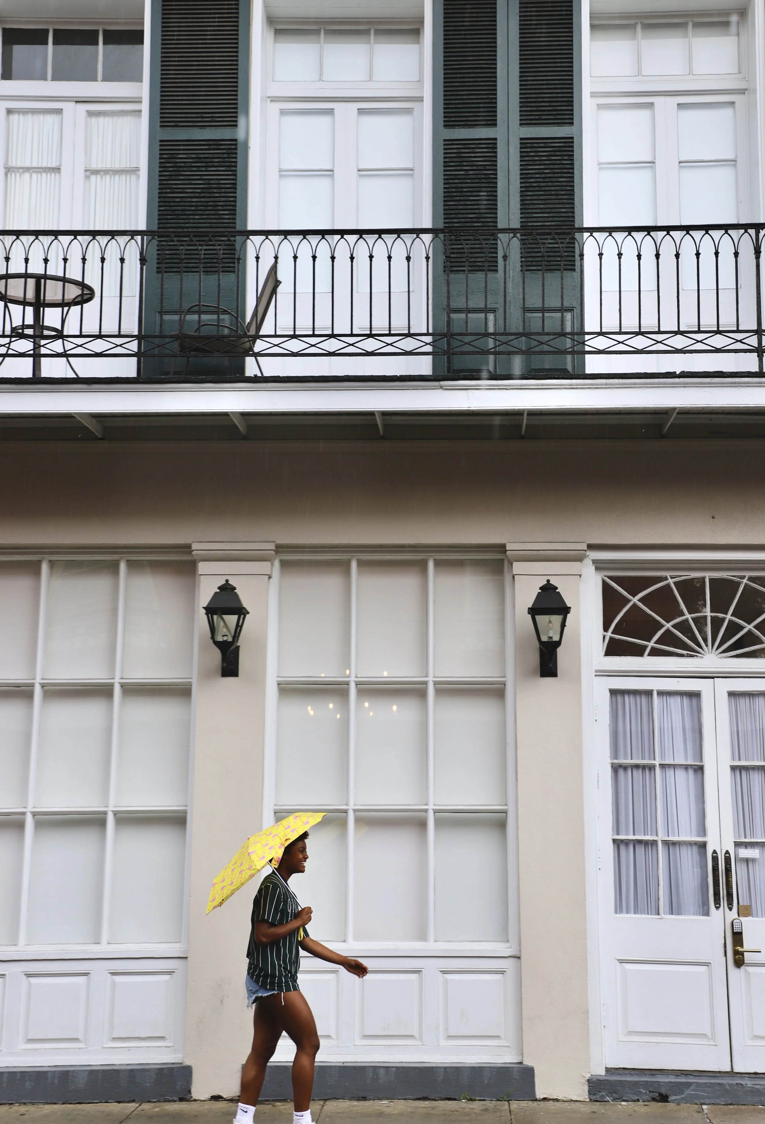  Simone walks across a street in the French Quarter. In this area of New Orleans, there is a wide variety of architecture in an array of colors.  