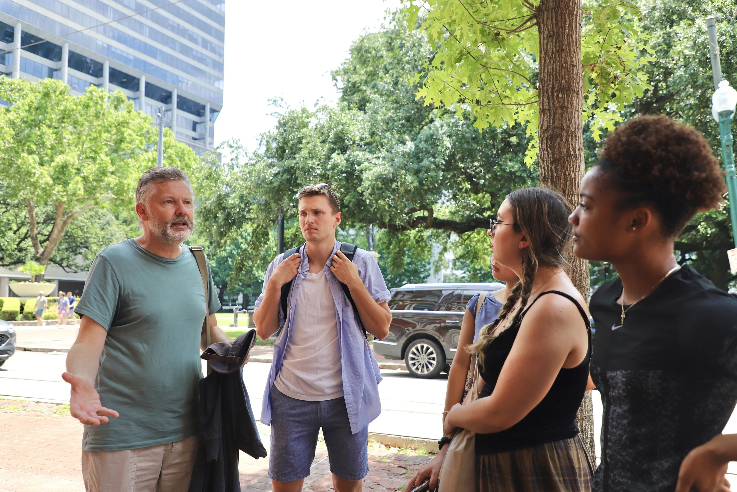  Andrew stands lecturing the group in front of a streetcar stop. This was the group’s first outing with the use of a streetcar to the Garden District.  
