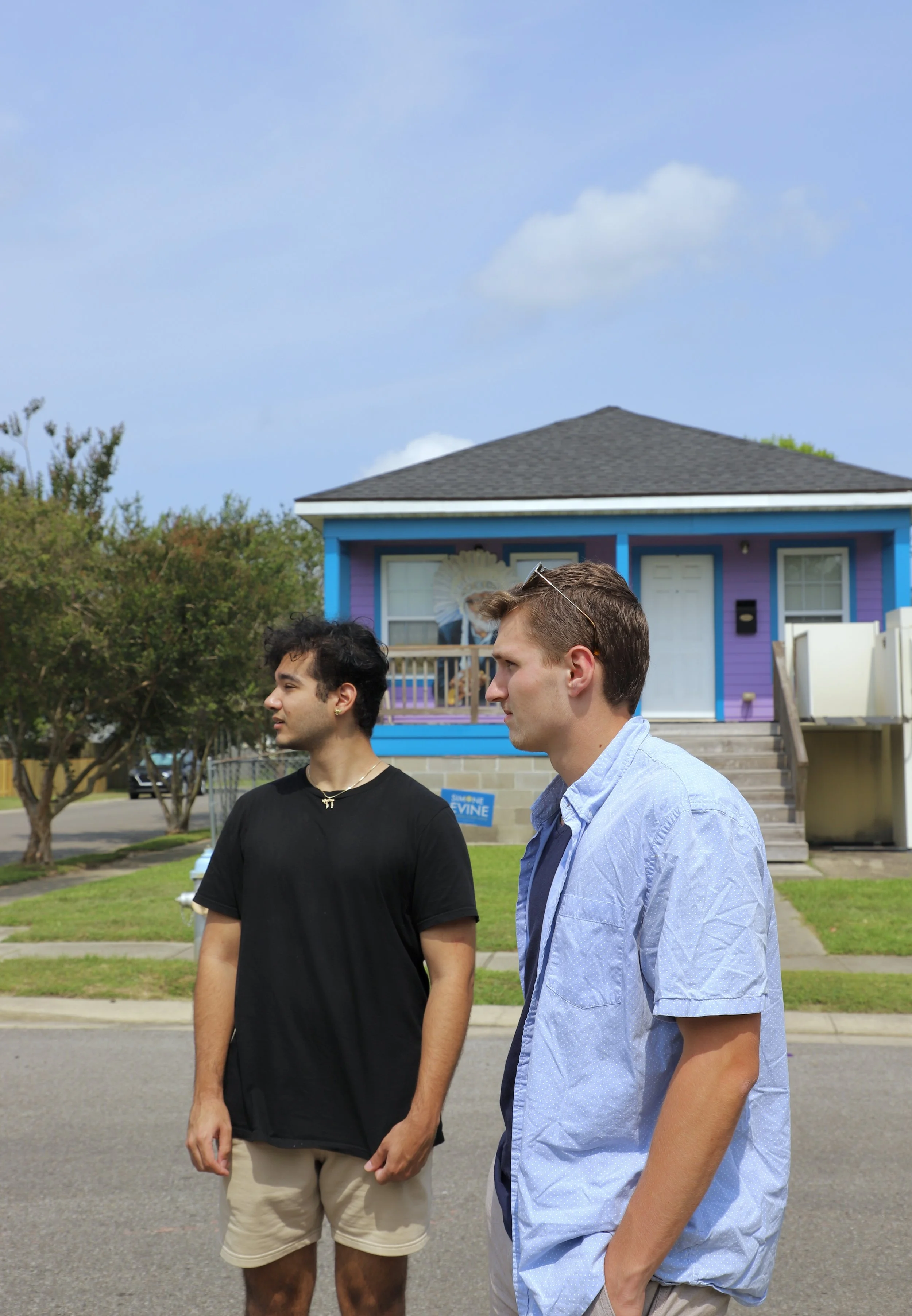  Cole and Aidan stand in the street in the “Music Village,” of New Orleans. In this area all of the homes are colorful and vibrant and there is a music school as well as a music themed park.  