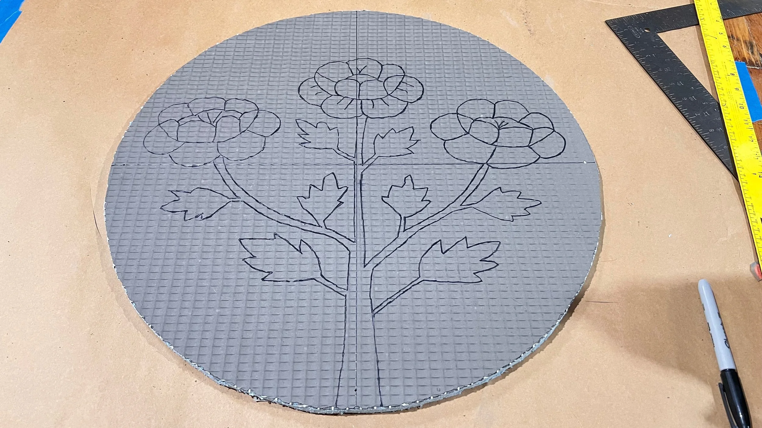 Wedi board circle with design outline drawn in preparation for the Cycles public art mosaic by Dyanne Williams