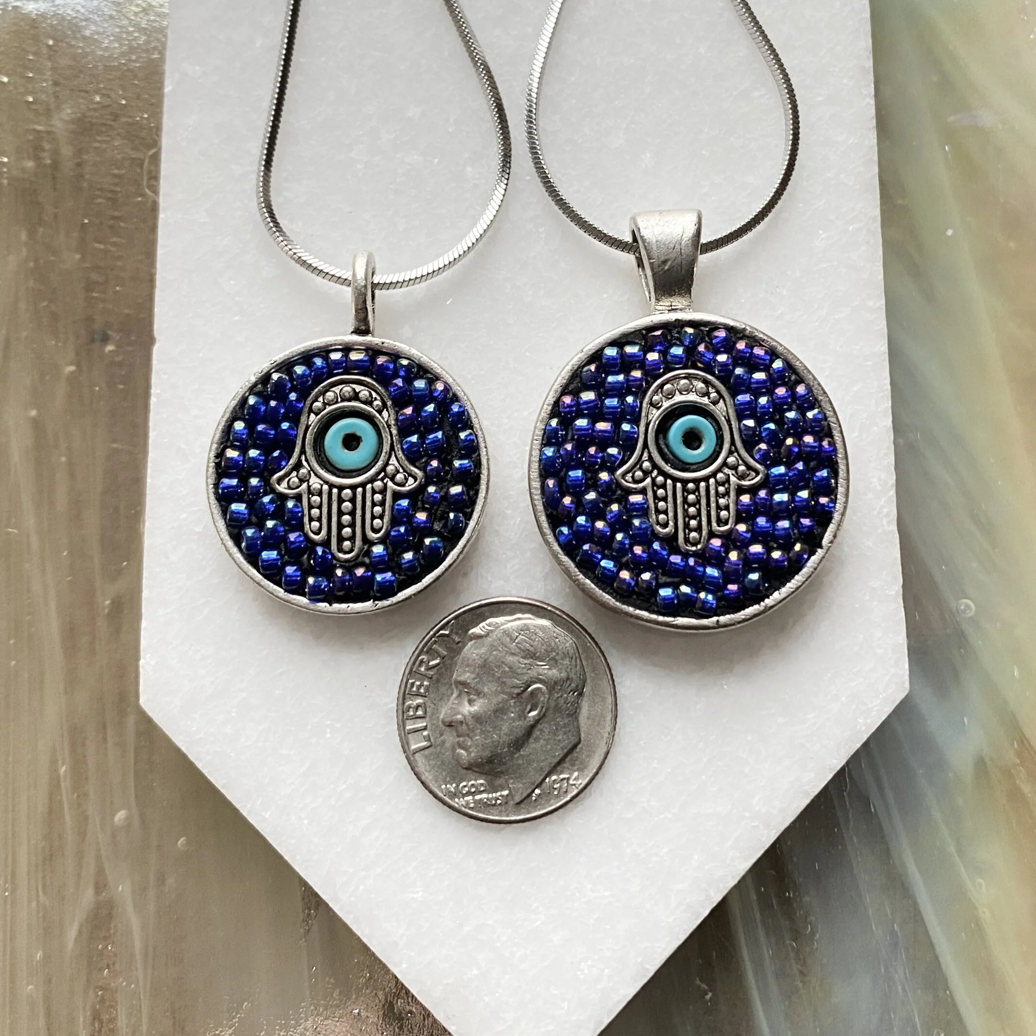 Mosaic pendant by artist Dyanne Williams next to dime for size reference.