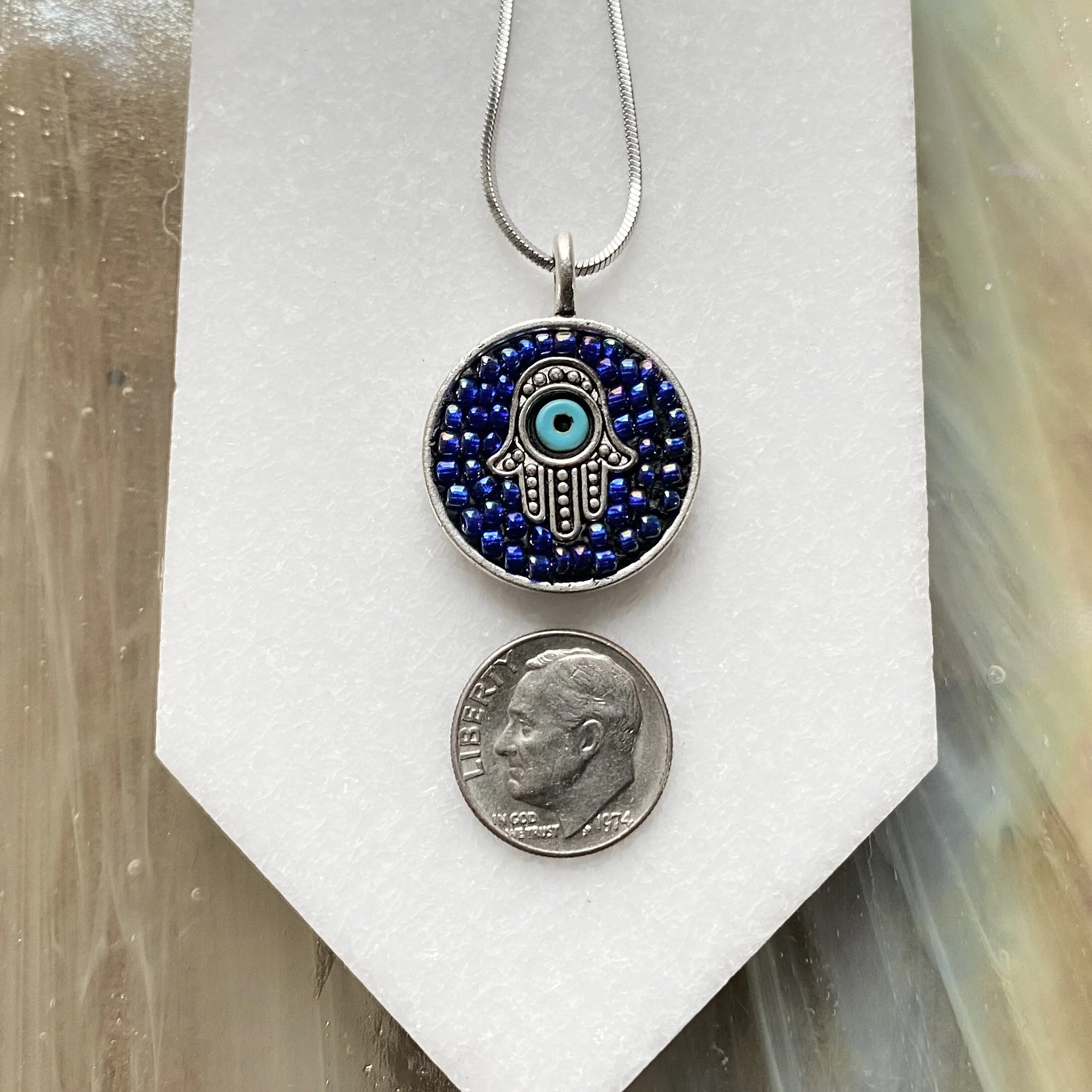 Mosaic pendant by artist Dyanne Williams on neck for size reference.