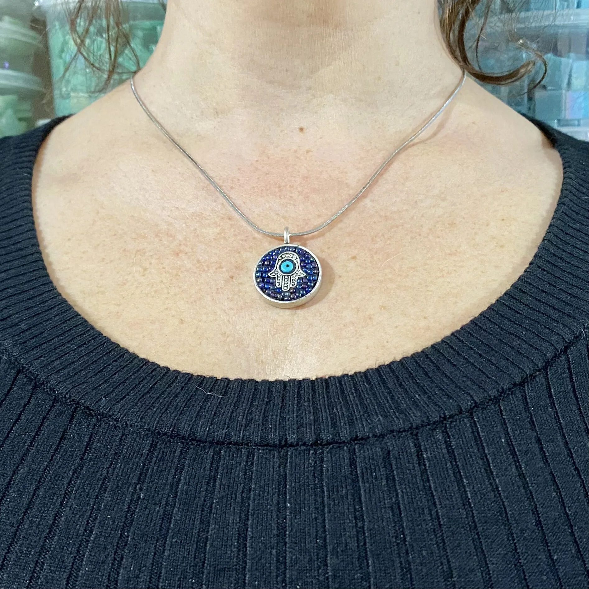Mosaic pendant by artist Dyanne Williams on neck for size reference.