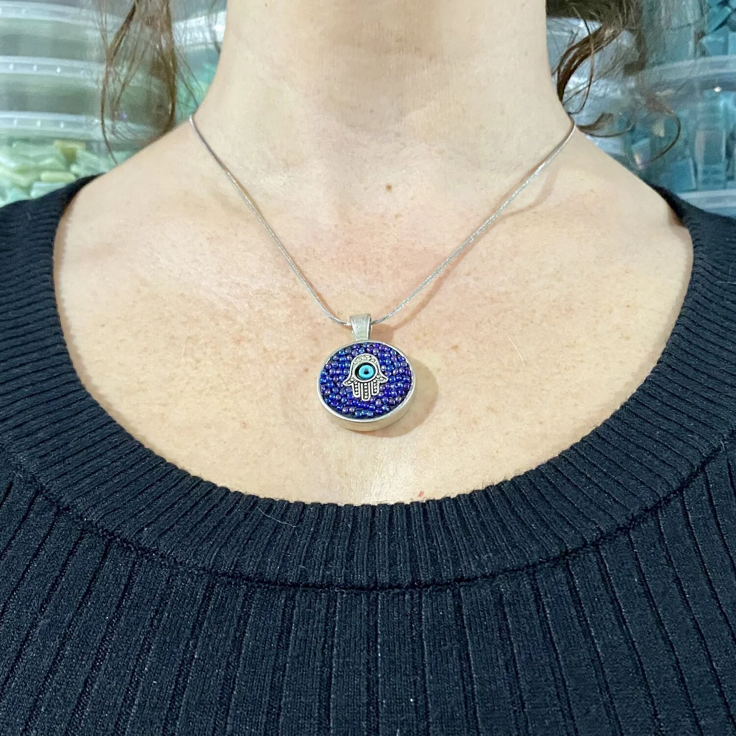 Mosaic pendant by artist Dyanne Williams on neck for size reference.