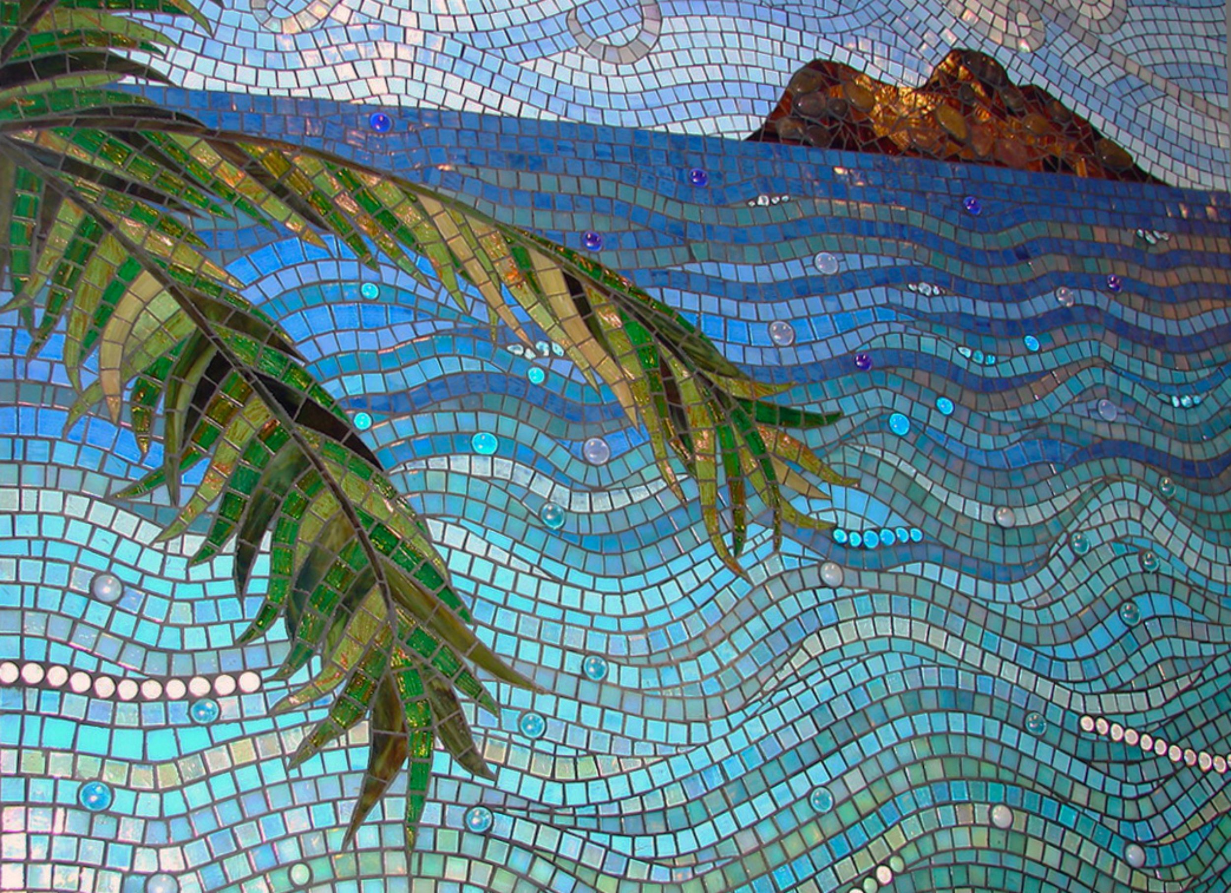 Detail of Mokuluas Islands mosaic backsplash showing iridescent glass palm fronds, ocean waves in blue and aqua tones, and the Mokuluas Islands in the distance