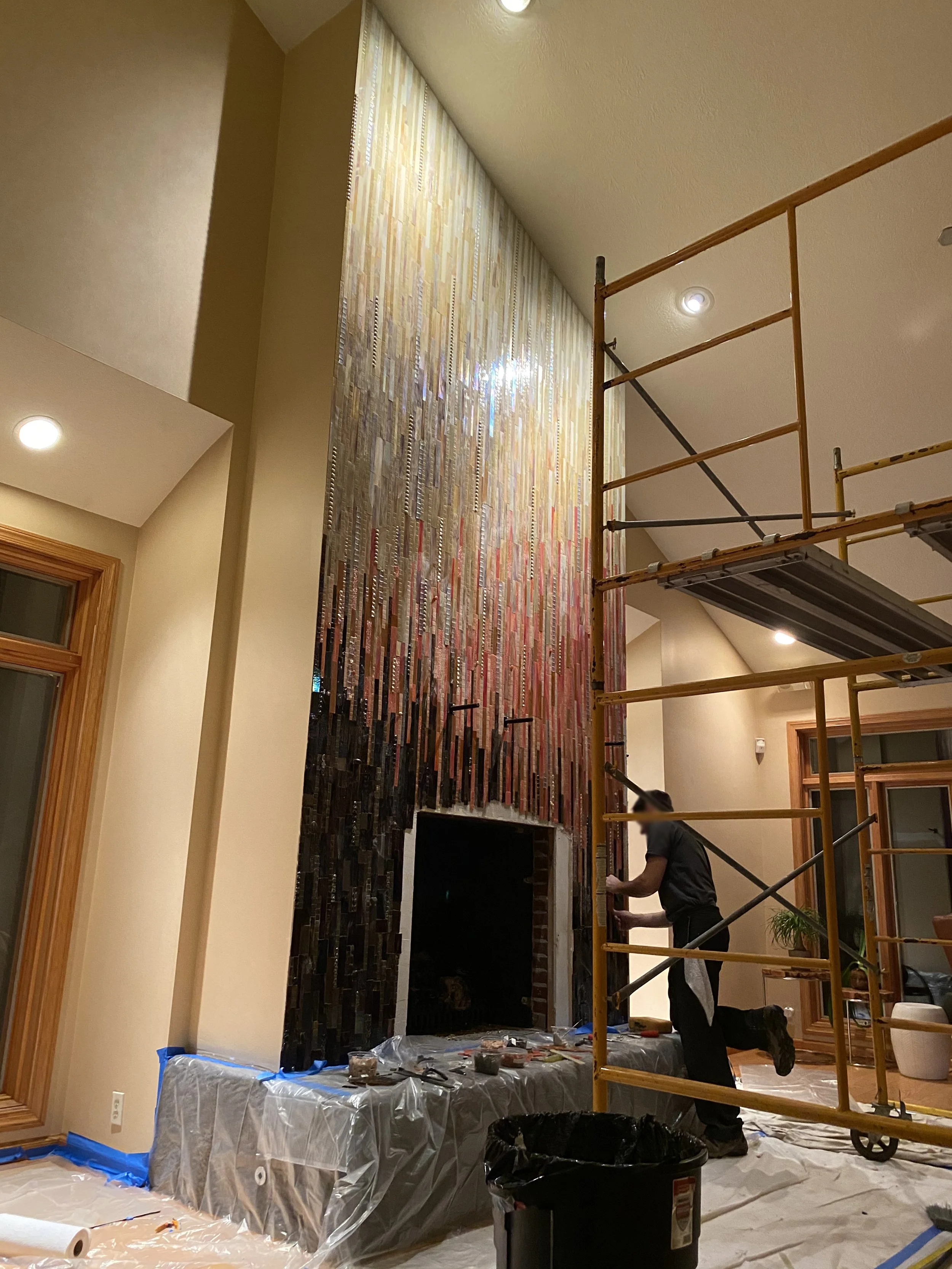 Installing the fireplace mosaic.