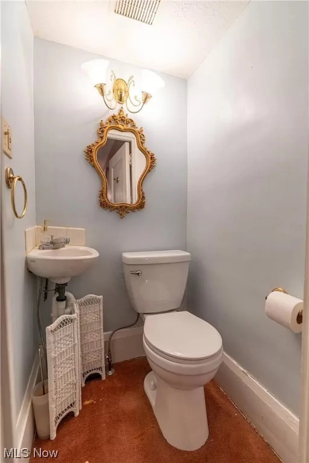 The powder room before renovation. Yes, that's carpet.